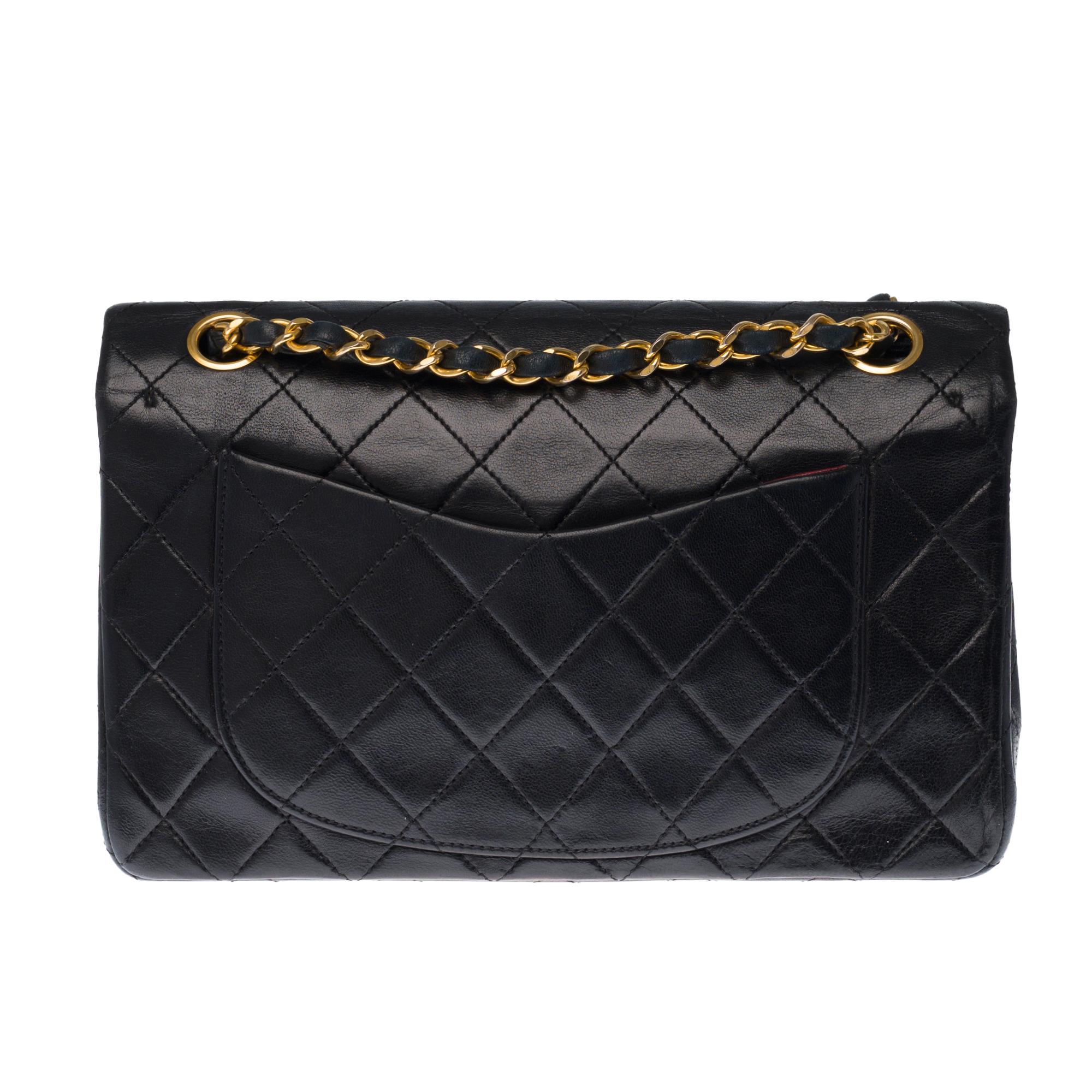 The coveted Chanel Timeless 23cm double flap bag in quilted black lambskin leather, gold metal hardware, gold metal chain interwoven with black leather.
Pocket on the back of the bag.
Flap closure, gold-tone CC symbol.
Double flap.
Zip on lower