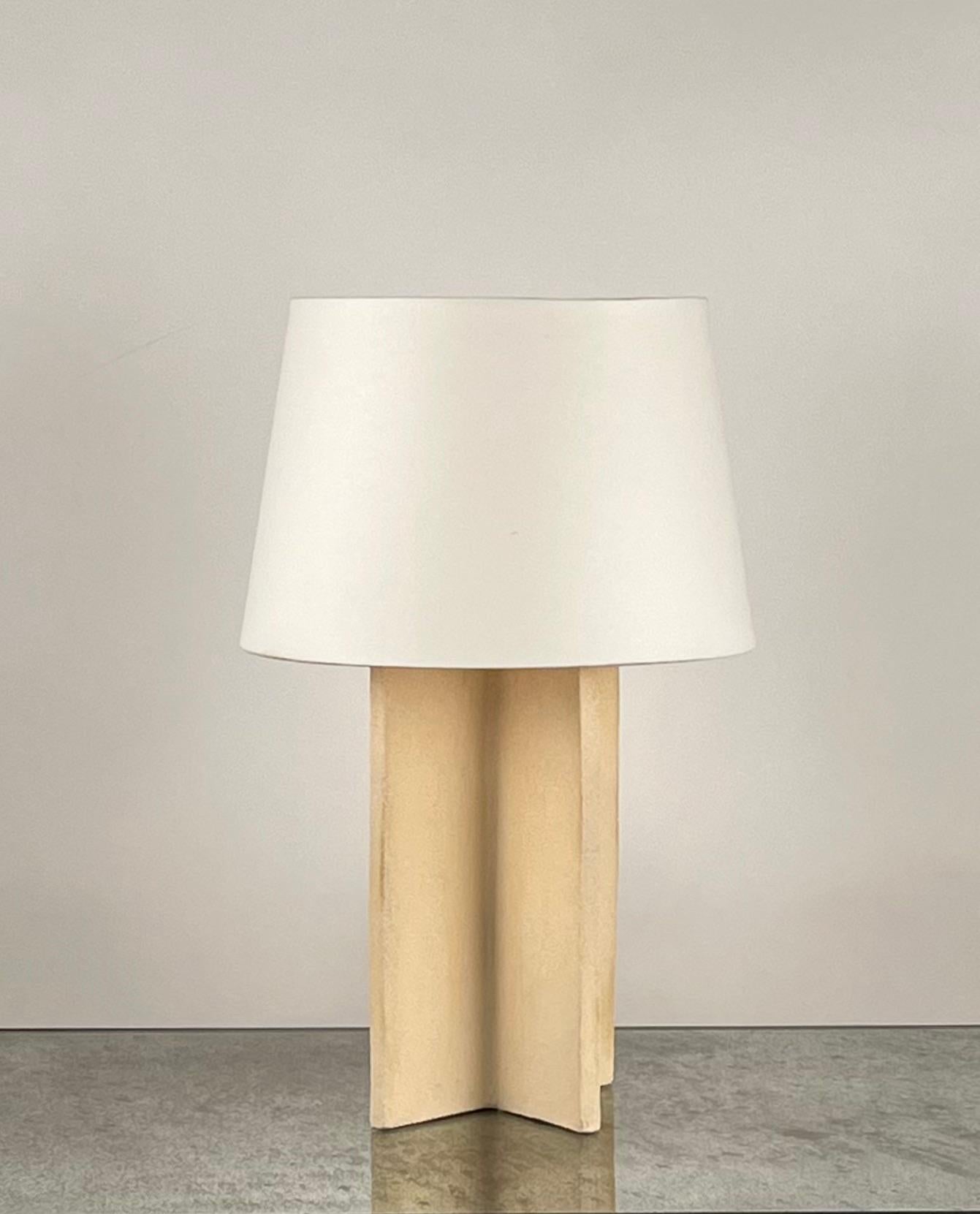 Chic 'Croisillon' cream ceramic lamp with parchment shade by Design Frères.

An attractive, understated combination of a ceramic crosspiece base with a cream matte glaze and a European style parchment shade (no harp or finial).

Dimensions listed