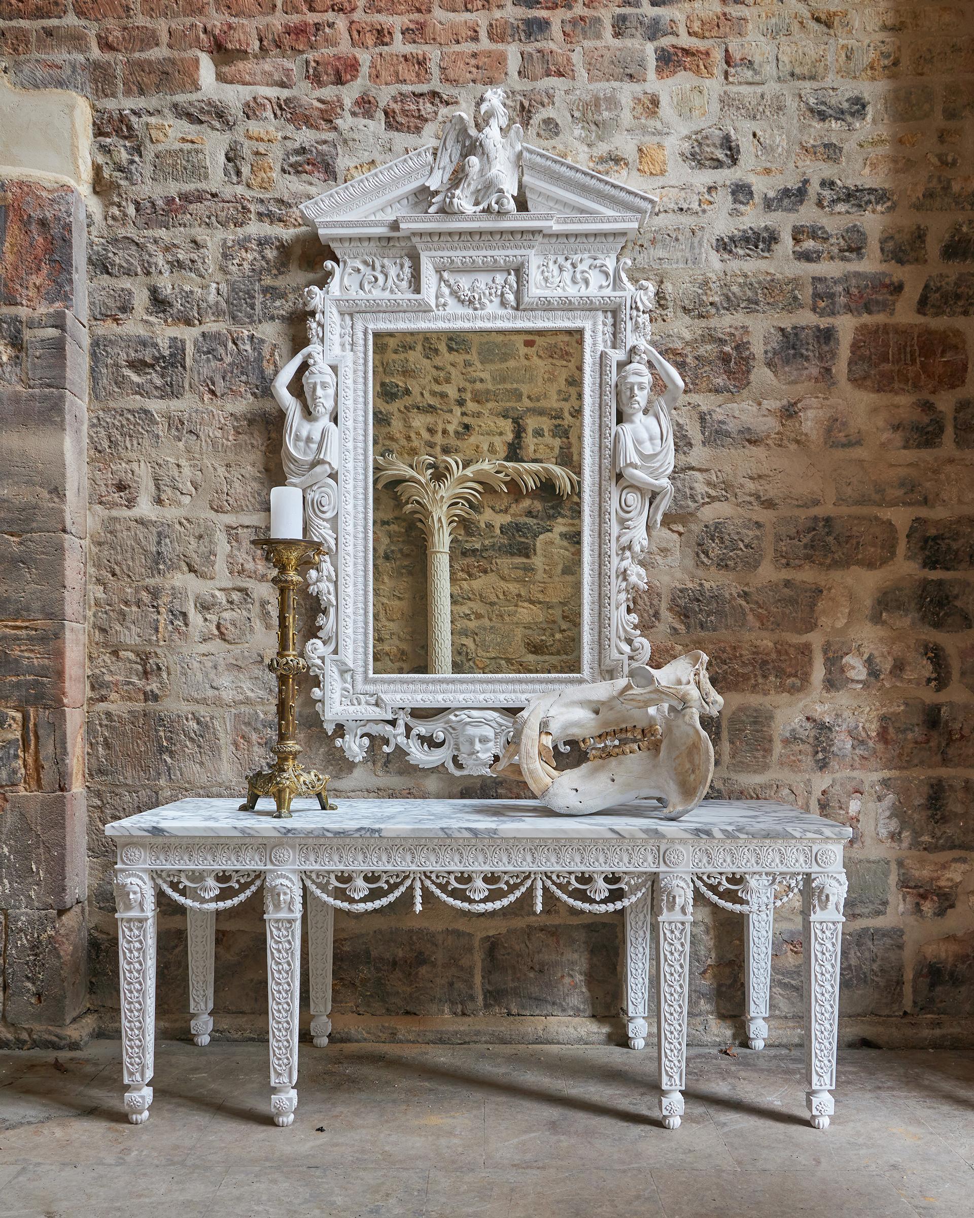 A truly exceptional carved console table after a design by Robert Adam. The profusely decorated table showing Adams delicate ornament to the full. Specialist aged gesso and paint evoking the ancient plaster works from Pompei. Bespoke finishing