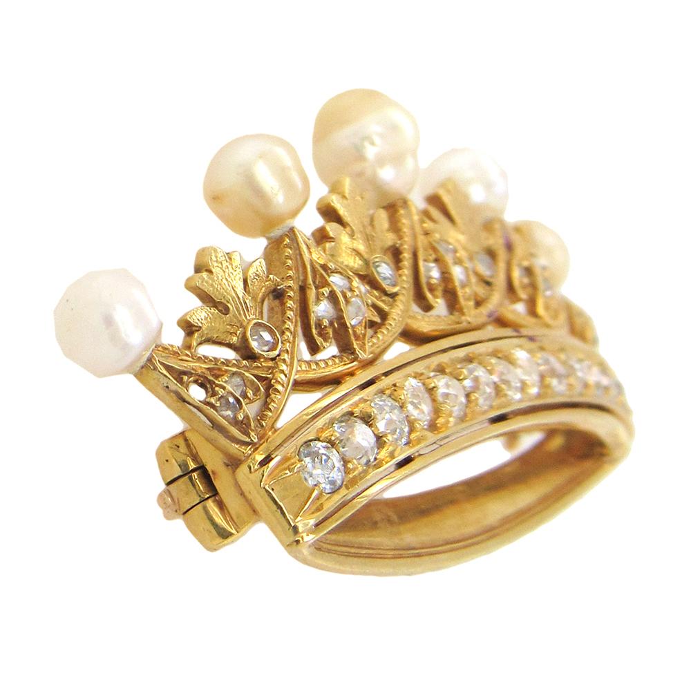 Crown brooch, circa 1930's, in 18K gold is set with rose-cut and old European cut diamonds and crowned with five baroque natural pearls. The brooch measures 2