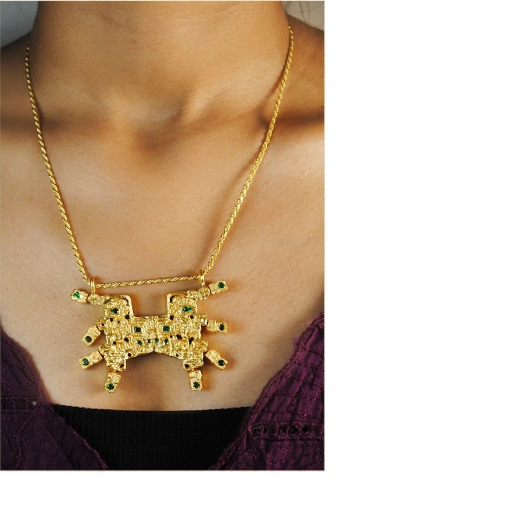 Inspired by the Central Andes, Peru, circa 1200 BC, this exquisite pendant echoes the Panther Mouth Mask of the Cupisnique/Chavín culture. Feline predators, key motifs in this culture, are depicted in a stylized, exaggerated manner, symbolizing