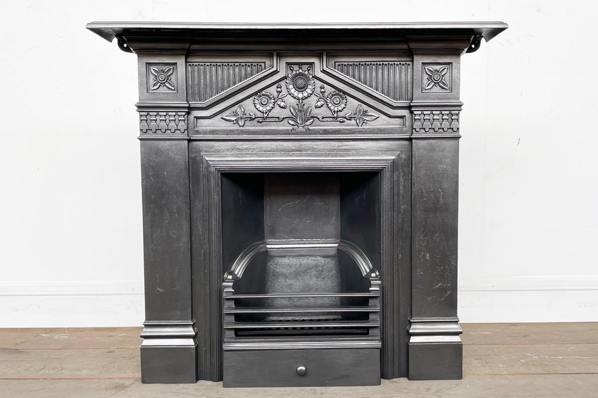 The Daisy, an ornate antique Victorian cast iron combination fireplace. This design was first registered in 1894 and was protected for 5 years. Dating this fireplace to between 1894-1899.

Finished with traditional black grate polish, ready for a