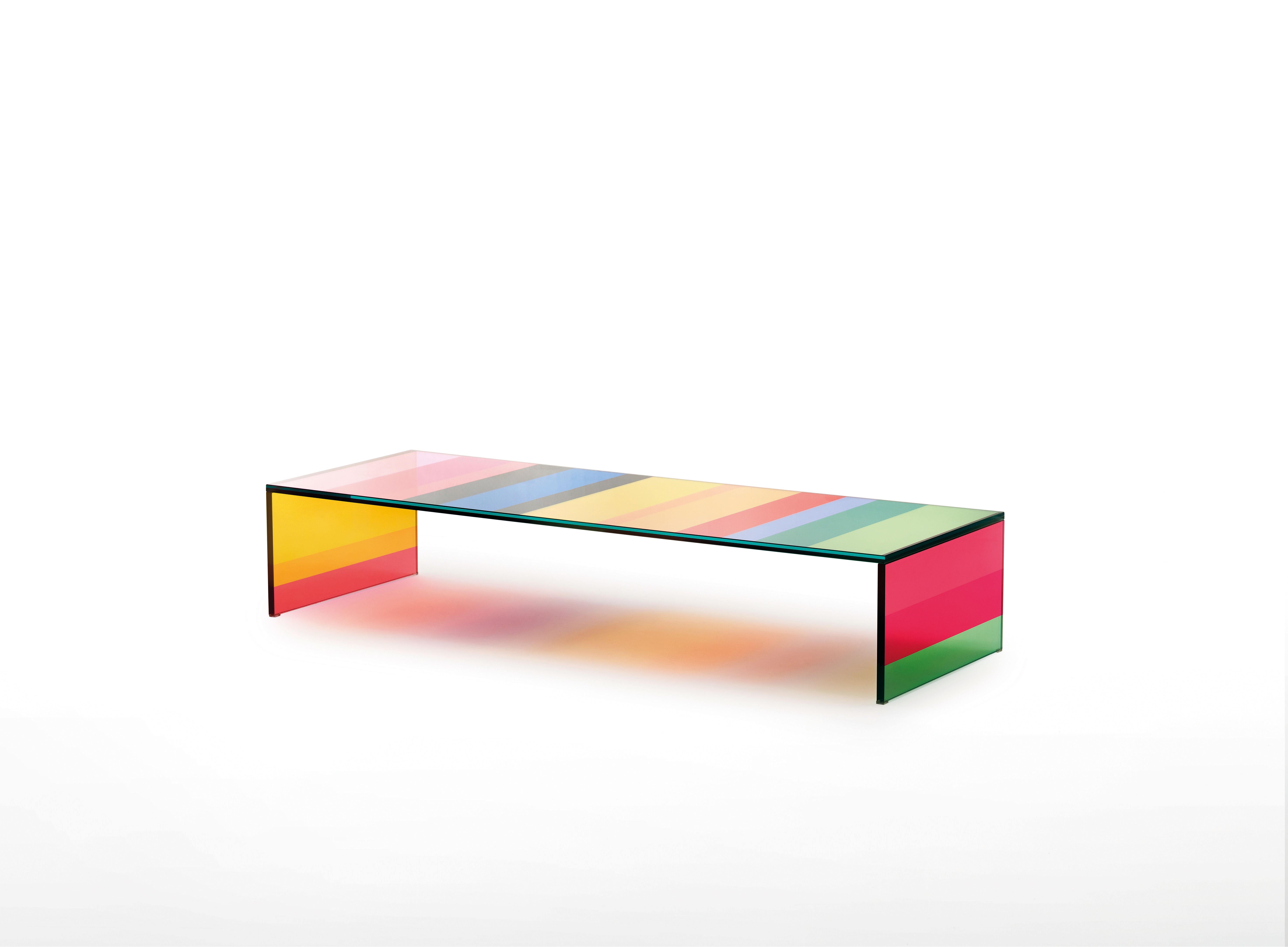 The dark side of the moon low table is shown here in the laminated transparent extralight glass in striped. Low table with bridge shape in laminated transparent extralight glass with a sophisticated and innovative technical process, thanks to which