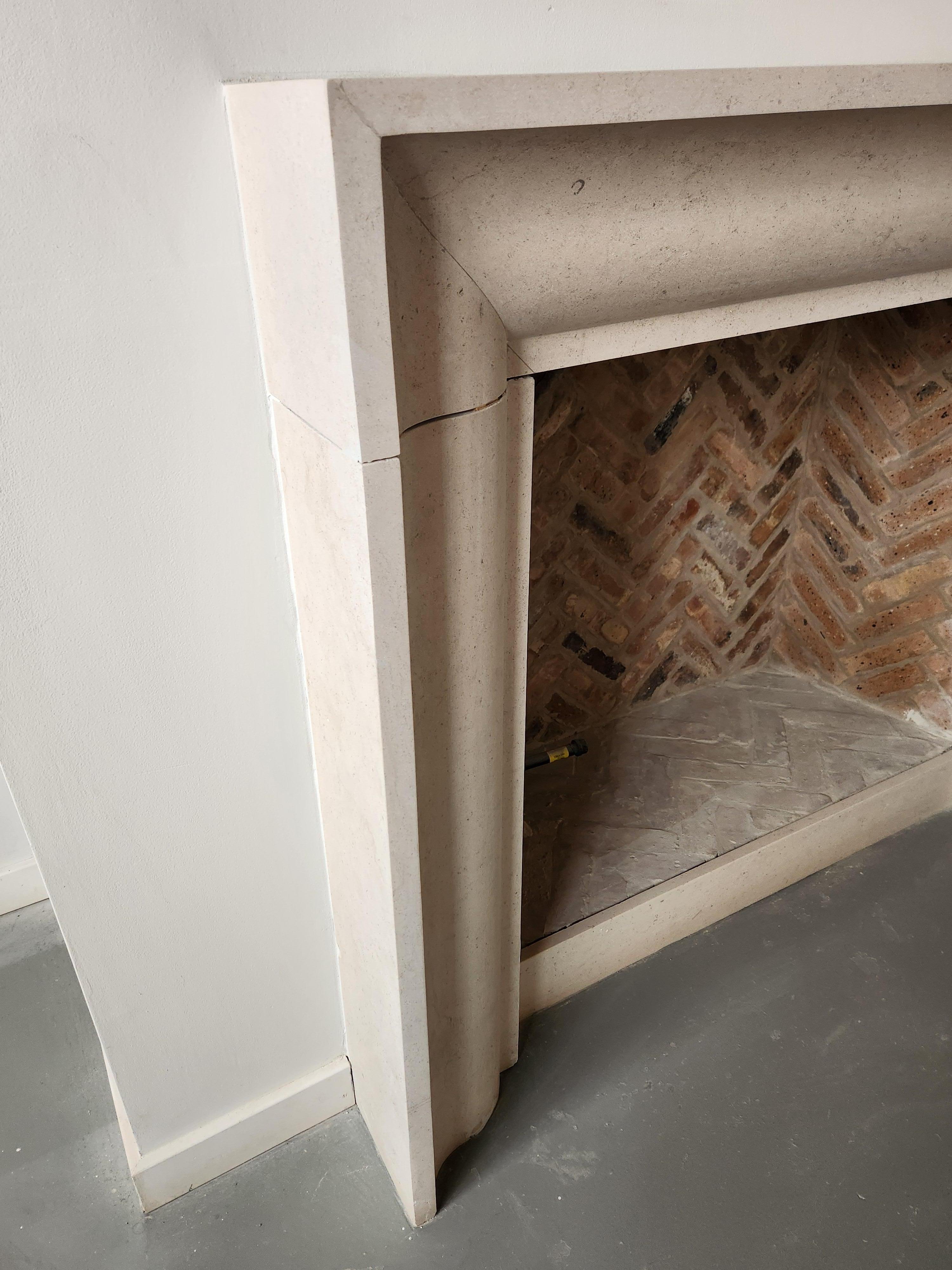 American The Deco: A Transitional Carved Stone Fireplace in the Art Deco Style For Sale