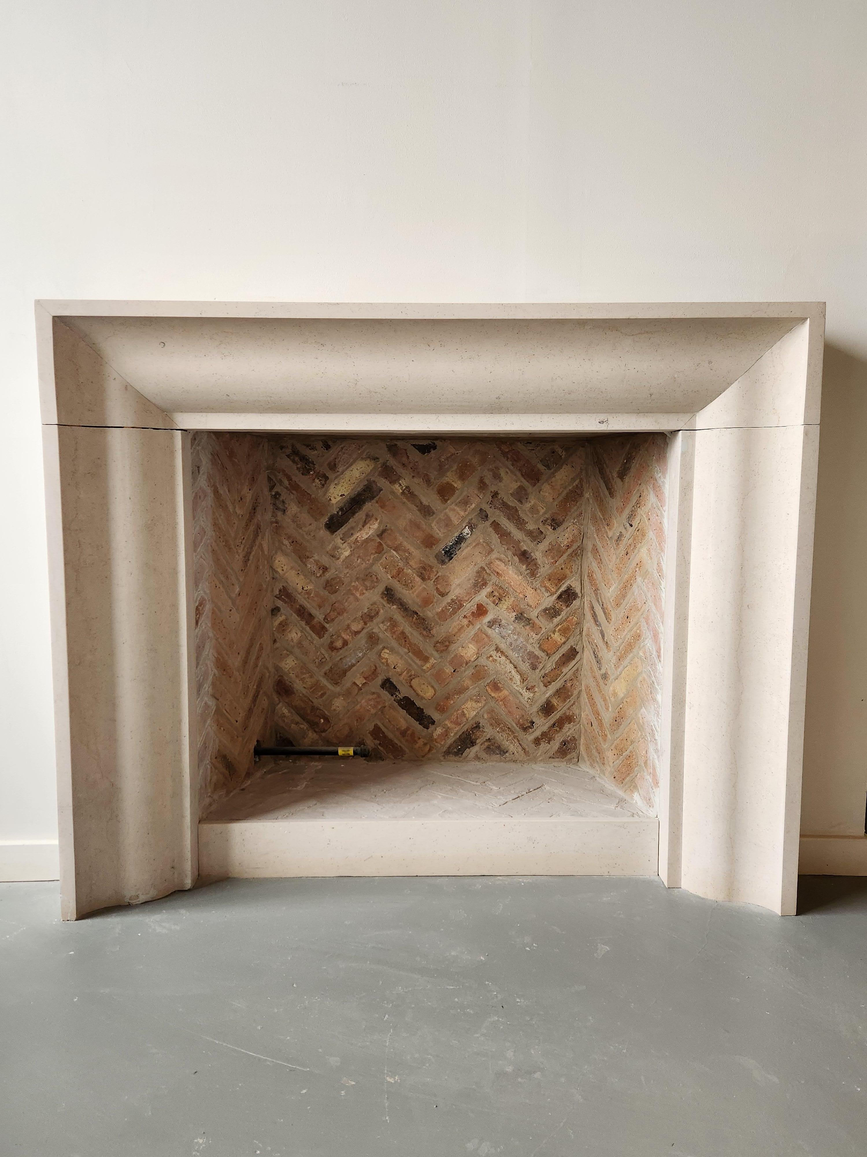 American The Deco: A Transitional Carved Stone Fireplace in the Art Deco Style For Sale