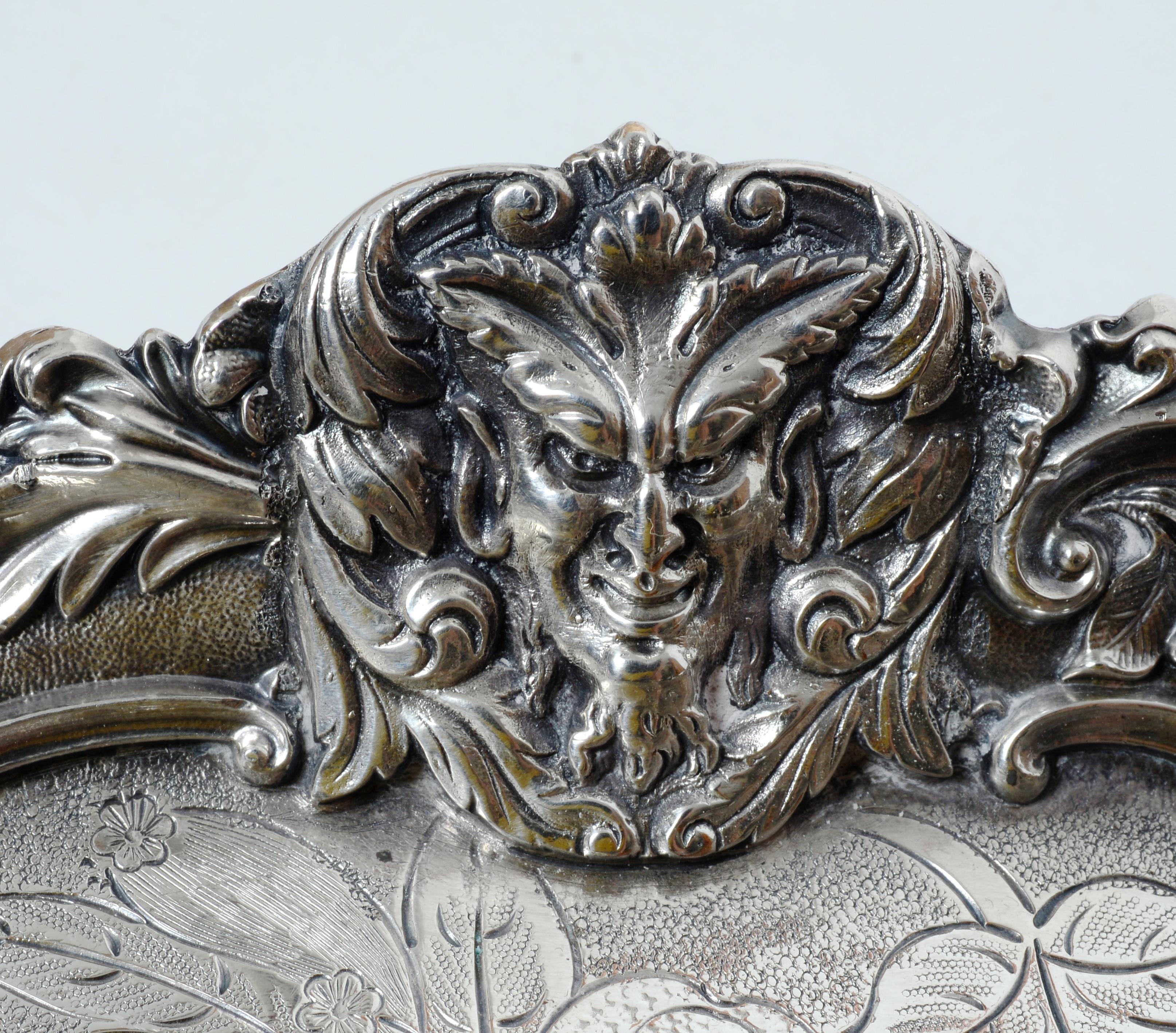 The Devil is in the Details, An Early 19th c Silver Plated Tray with Devil's Face Cast in the Gallery. The gallery has 3 Devil faces flanked by scrolling leaves. The interior with engraved fruit and leaves. The use of the devil on silver objects in