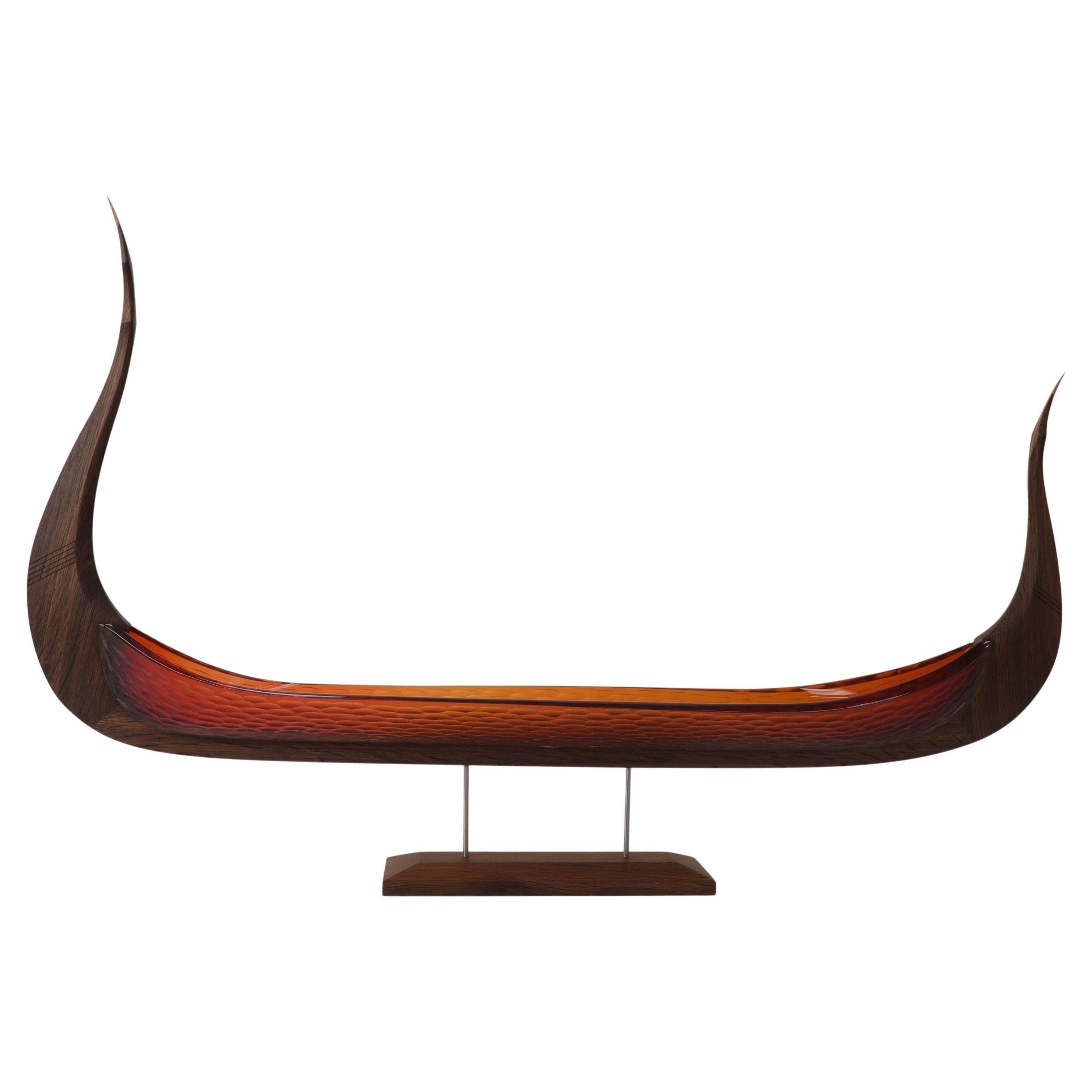 The East Wind, a red glass & oak viking ship by Backhaus & Brown and Egeværk
