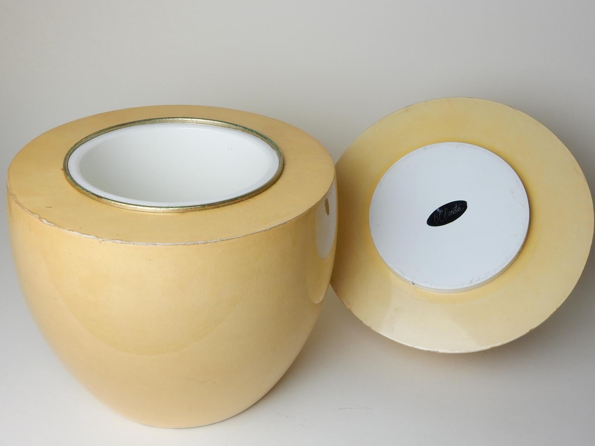Rare oversize ~egg~ ice bucket by designer Aldo Tura, signed.
Made in Italy circa 1950s.
Wood form wrapped in glowing goatskin parchment.
Brass trimmed plastic inner bucket.
  