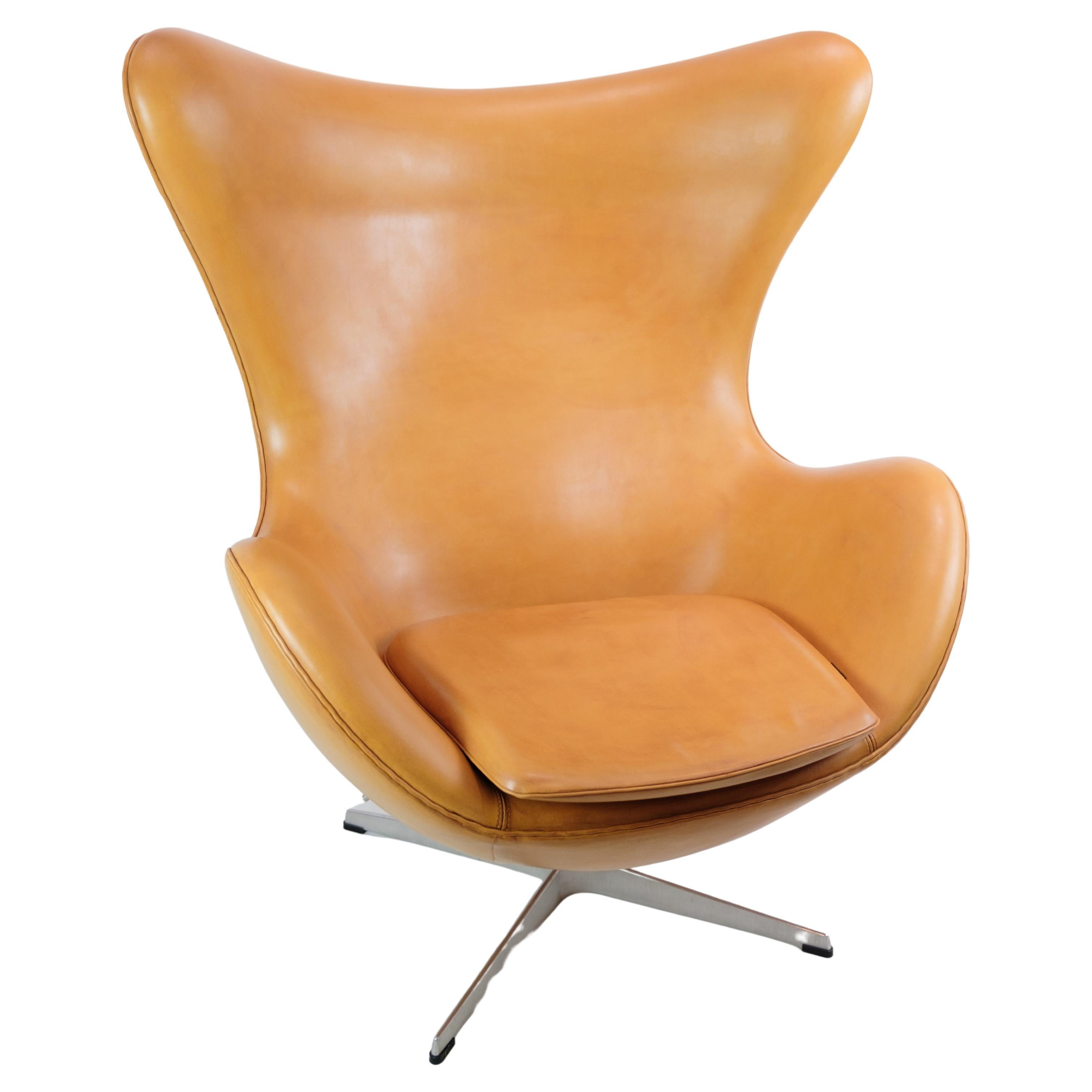 The Egg, model 3316, was designed by Arne Jacobsen in 1958 and manufactured by Fritz Hansen. This particular chair, made around 2000, features original upholstery in cognac elegance leather.

Arne Jacobsen, a prominent Danish architect and designer,