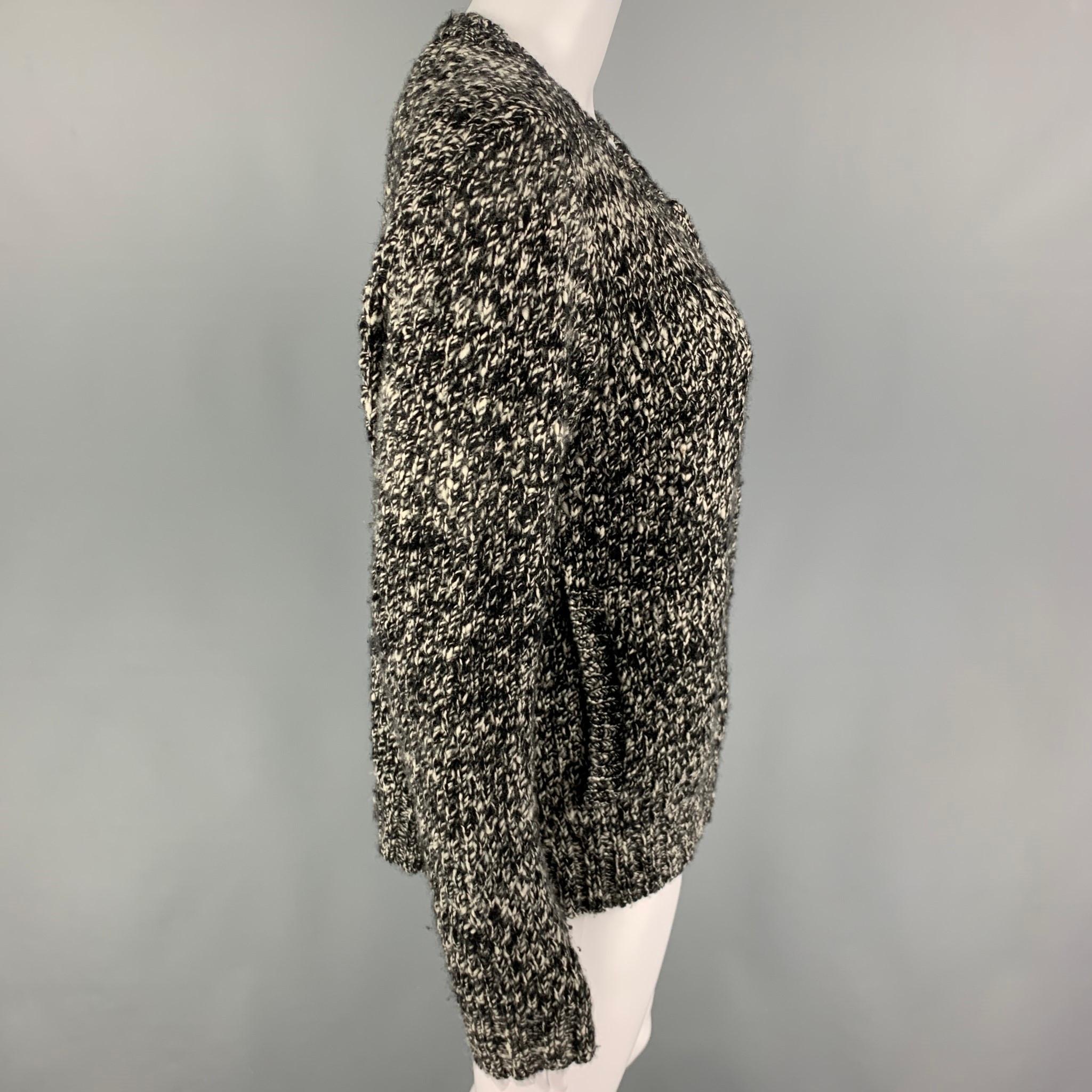 THE ELDER STATESMAN cardigan comes in a black & white marbled knitted cashmere featuring a collarless style, slit pockets, and a full zip up closure. 

Excellent Pre-Owned Condition.
Marked: S

Measurements:

Shoulder: 17 in.
Bust: 40 in.
Sleeve: 26