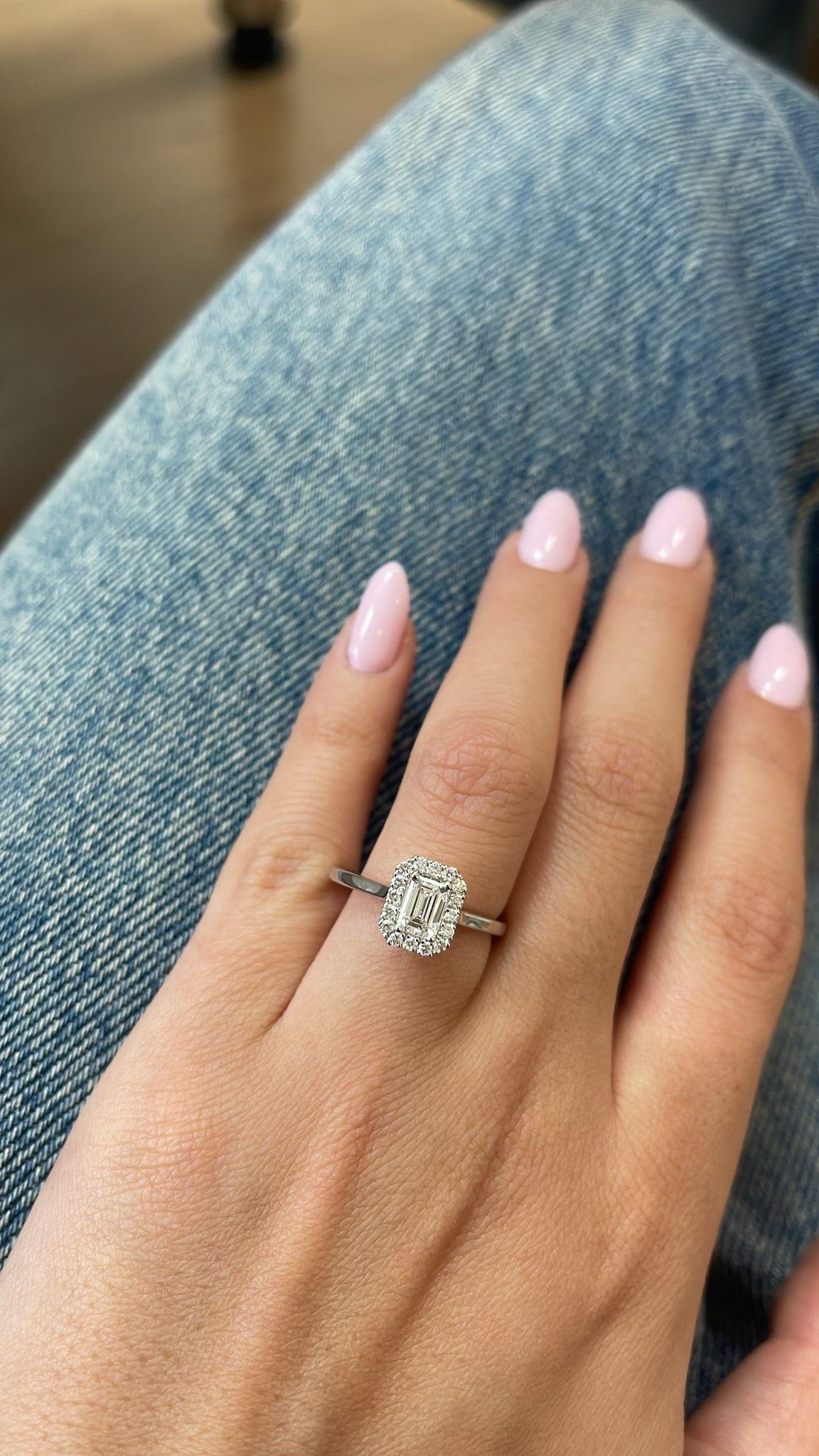 Crafted in timeless 14K gold , this exquisite ring showcases a breathtaking 0.86-carat EMERALD-cut natural diamond at its center, graded D color, VS clarity for exceptional brilliance and purity.

Encircling the centerpiece is a graceful halo of 16