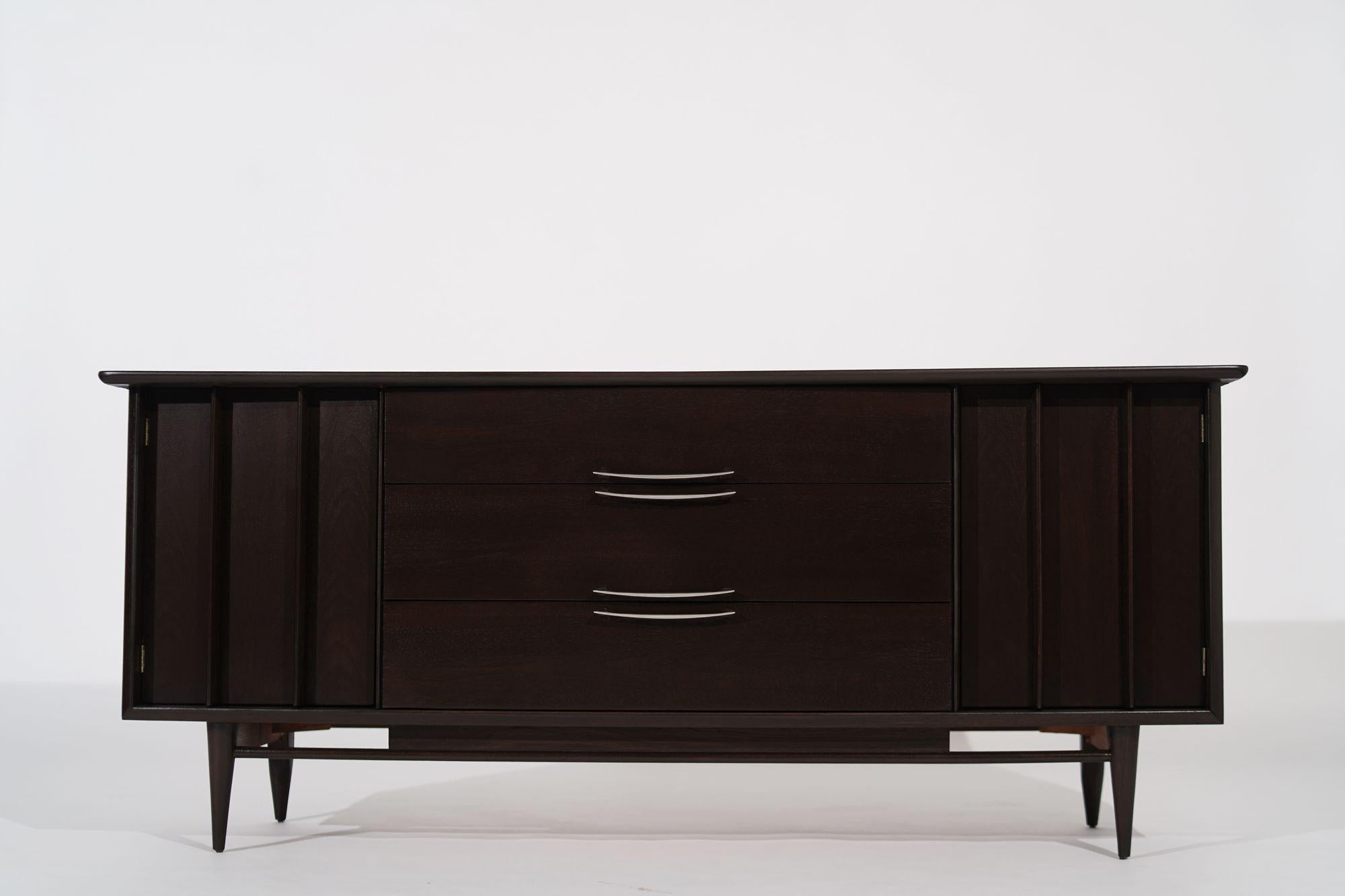 A beautiful Mid-Century Modern credenza by Kent Coffey, circa 1950-1959. Executed in walnut, completely restored. 
Other designers from this period include Paul McCobb, Paul Frankl, Jens Risom, and T.H. Robsjohn-Gibbings.