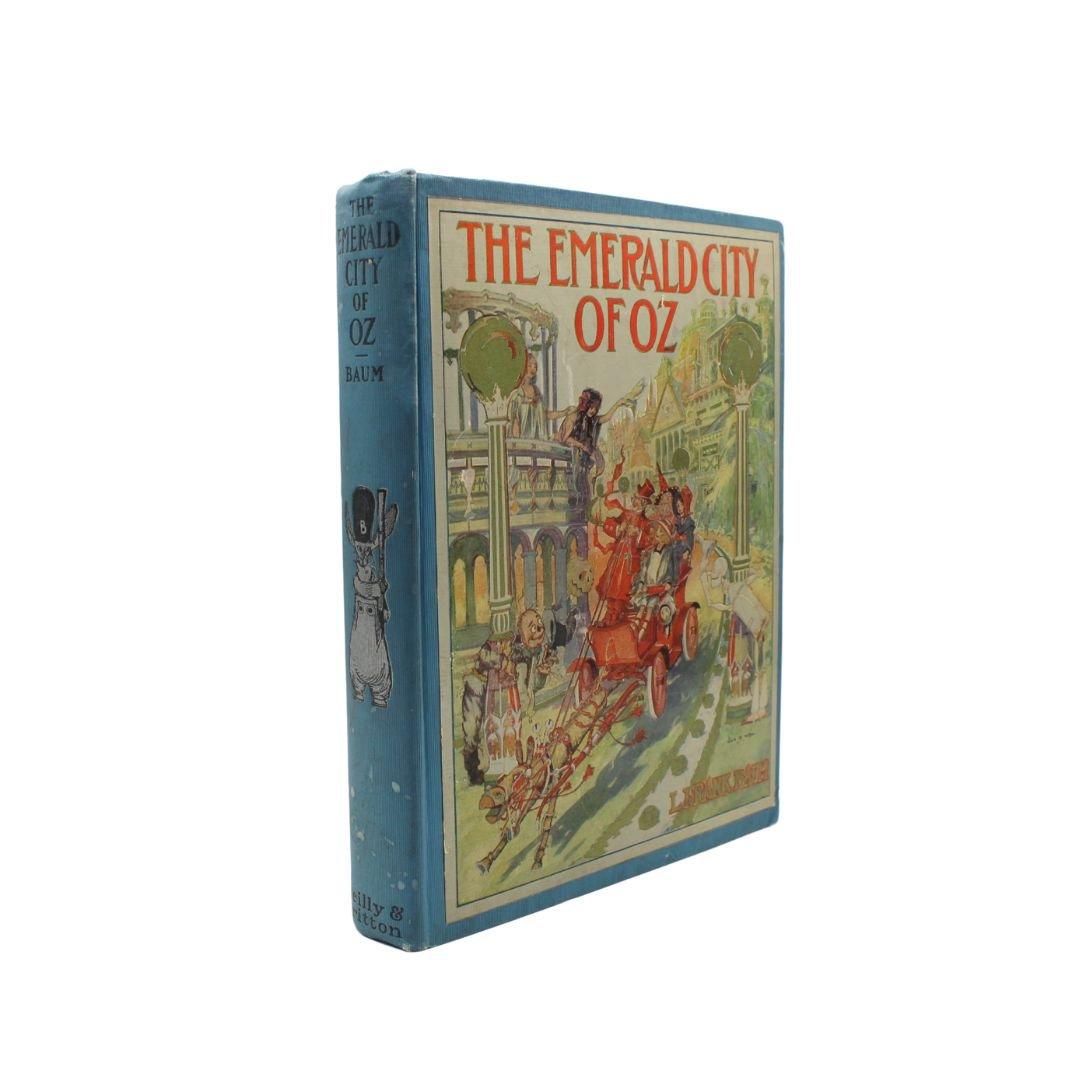 Baum, L. Frank. The Emerald City of Oz. Illustrated by John R. Neill. Chicago: The Reilly & Britton Co., (1910). First edition, first state.  Large octavo. In the original publisher’s binding “A” blue hardcover boards with cover paper illustration