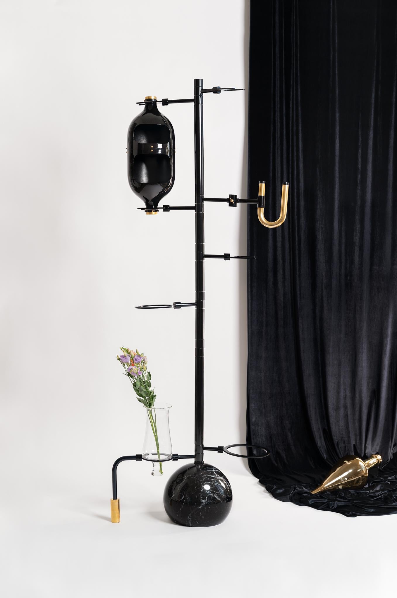  Interior designer Hania Jneid looked to chemistry sets when designing her elaborate floor lamp, named the Emotional Lab light.

The Emotional Lab floor lamp consists of a slender metal stand supporting several beaker-like glass vessels that light