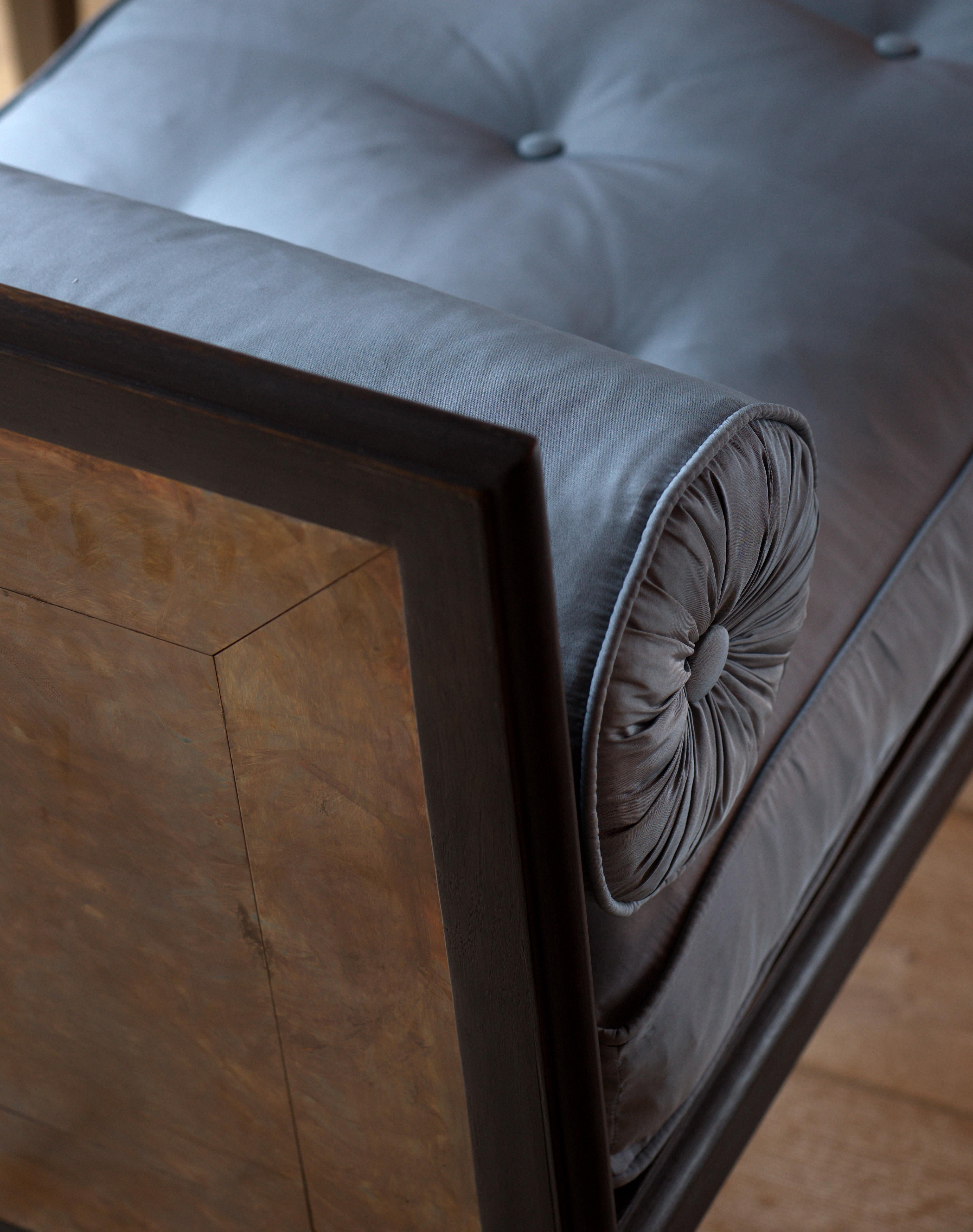 An ebonized oak and patinated bronze mounted window seat of neoclassical form, the cushion and bolsters covered in silk taffeta.
B.B. - Drawn up in front of a fire, at the end of a bed or simply in front of a window. I love the contrast of the