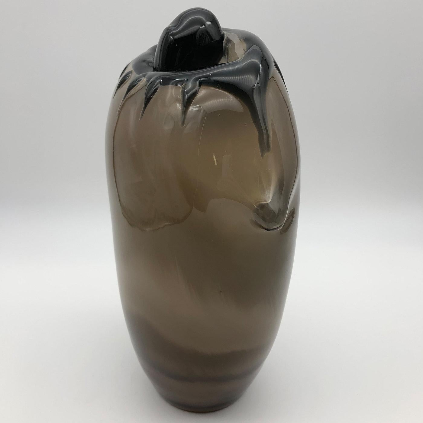 A superb design that combines art and functionality, this magnificent vase is meticulously handcrafted of glass by Ars Murano's expert glassblower Toso Cristiano. Showcasing a combination of white and dark amber hues seemingly melting and dripping