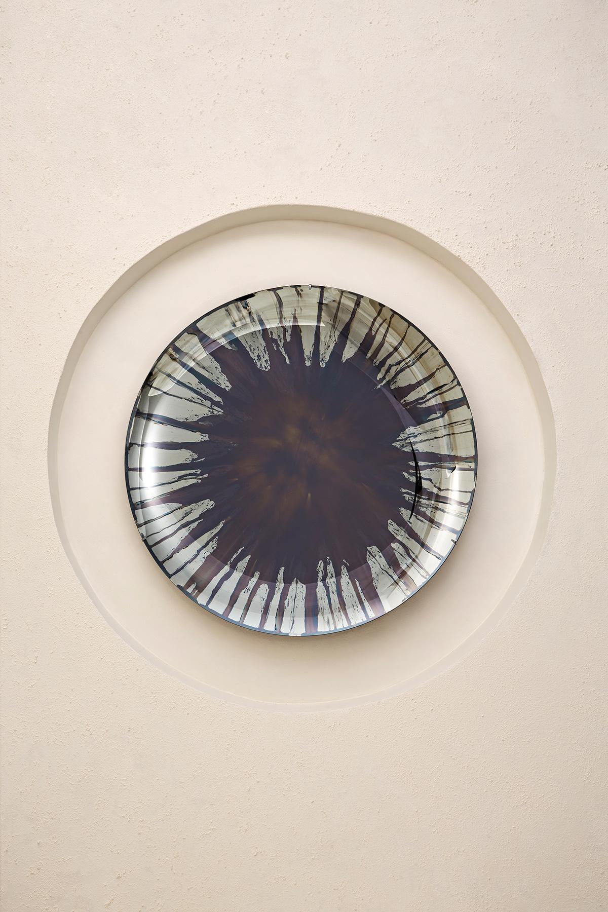 Concave Mixed Technique Mirror.
Ø97 cm  Depth: 7 cm  Thickness: 4 mm 
Colour: Multicolor  Hanger: Brass

The EYE OF THE UNIVERSE: This collection explores different techniques in glass and presents innovative approaches to mirroring, challenging the