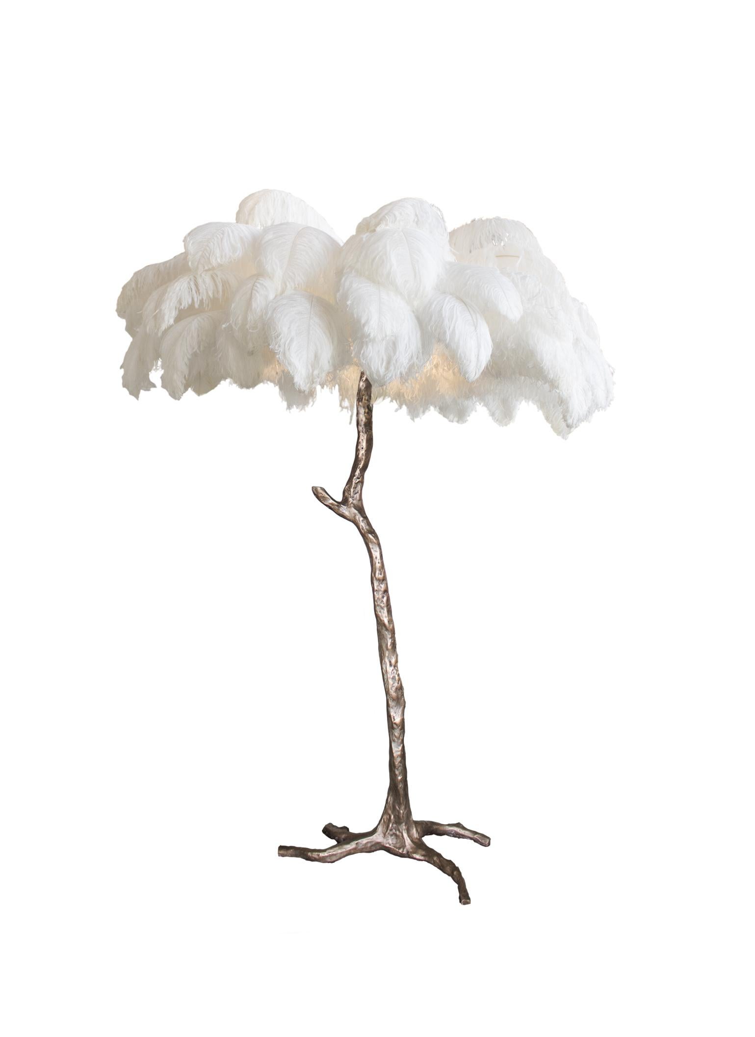 The ostrich feather lamp, edition piece by A Modern Grand Tour. An illuminating palm tree, resplendent with exquisite ostrich feather foliage, the feather lamp takes centre stage in any luxury setting and delivers the ultimate midas touch to