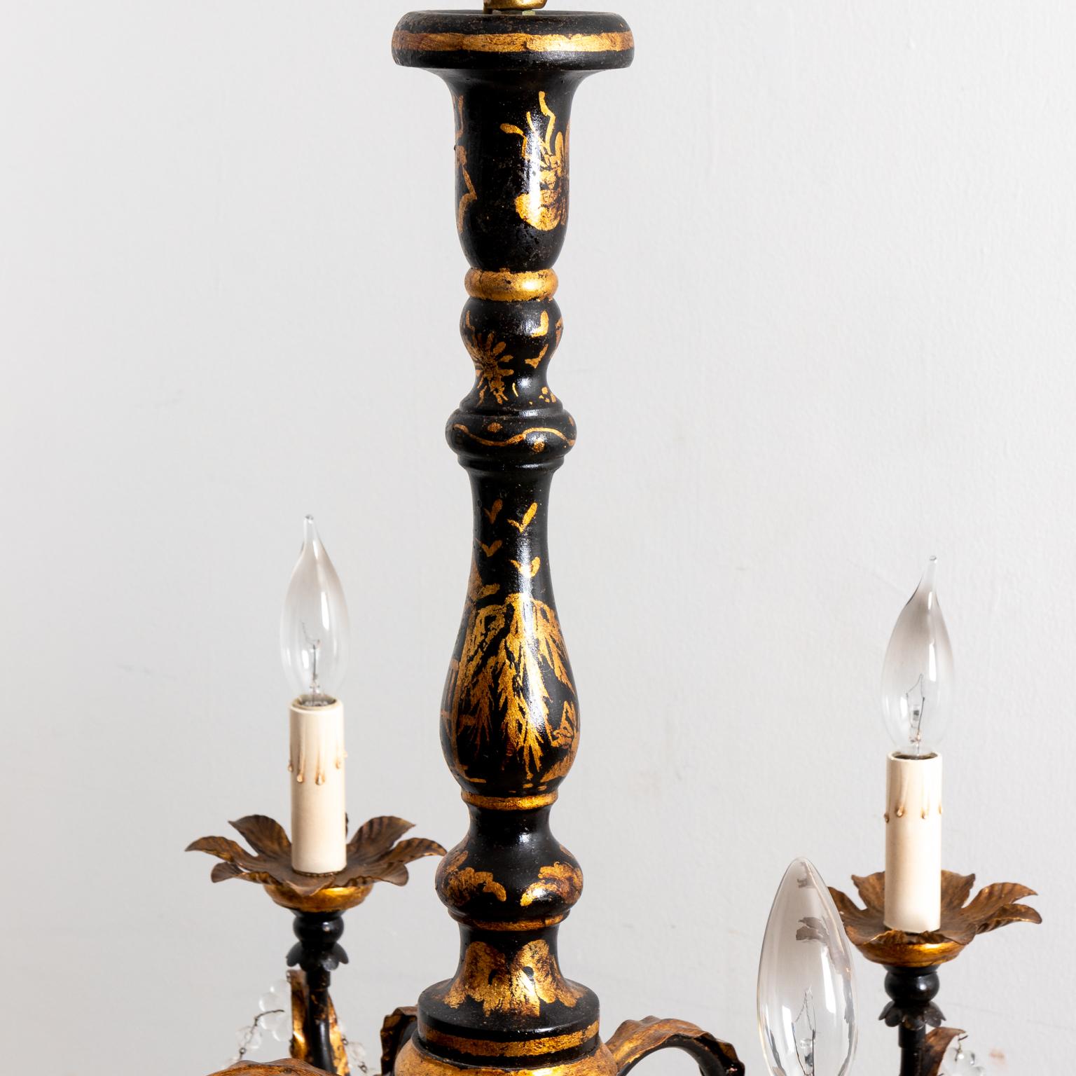 Circa 2000s black Chinoiserie style chandelier by American based lighting and reproduction furniture company called The Federalist. The piece is constructed in metal with wood gold gilt accents, further adorned with draped crystal swags and black