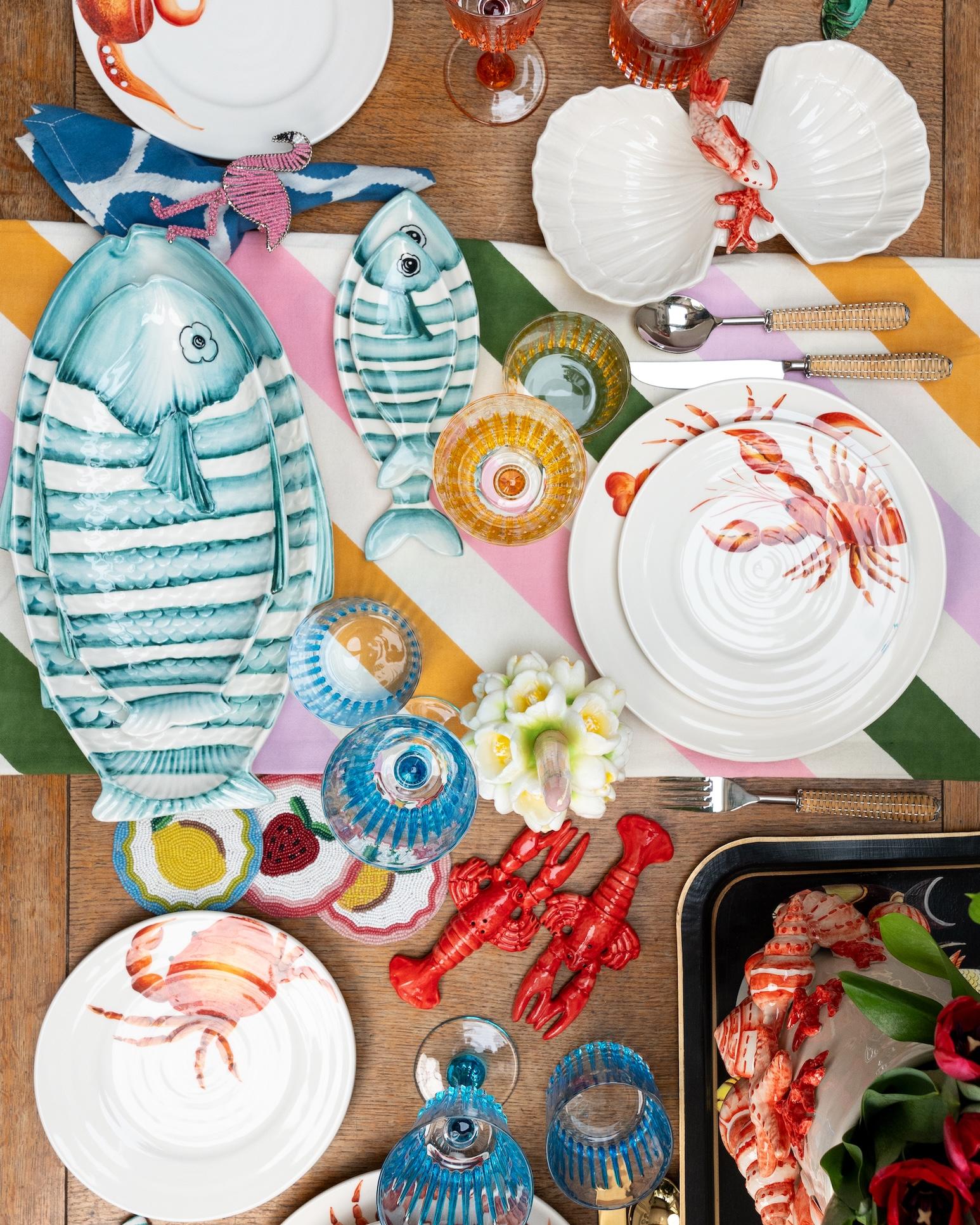 Celebrate the beauty of the sea with The Fishes ceramic tray, hand-crafted and hand-painted in the shape of a fish. Featuring charming fish motifs rendered with expressive brushstrokes and vibrant colors, each tray is a one-of-a-kind piece that