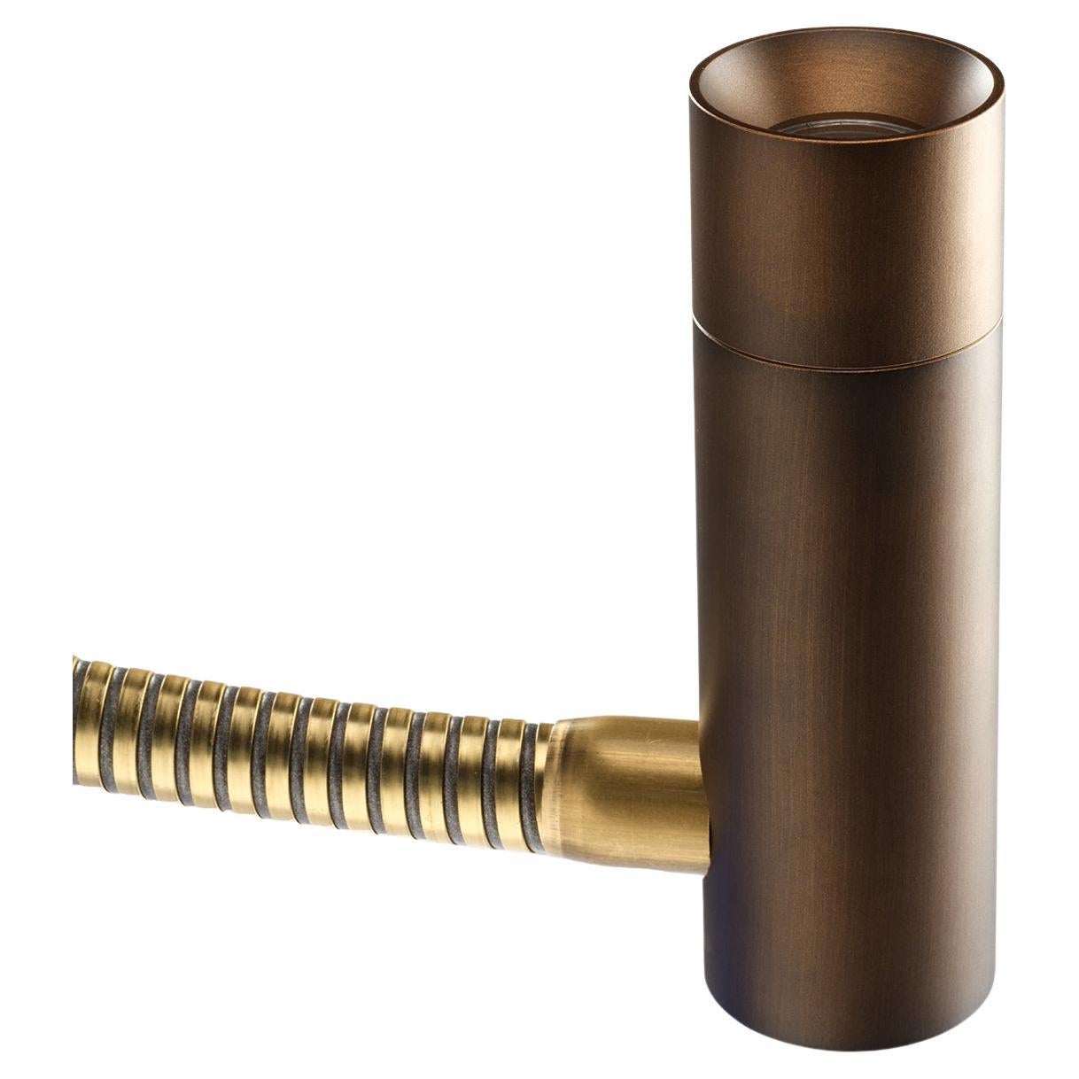 A solid brass frame conceived for a safe design distinguishes this reading lamp, its flexible stem allowing for the orientation of the LED light stream easing late-night reading sessions. Geometric elegance is stated by the cylindrical shape of the
