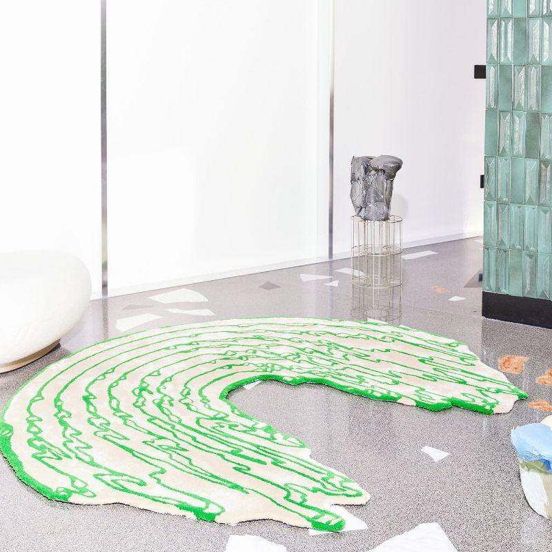 This eccentrically shaped rug hand-tufted from New Zealand wool and Tencel lyocell embodies the aesthetic of this green-and-white rainbow, seemingly melting like flowing lava. The initial fluff is a normal effect that fades away with constant vacuum