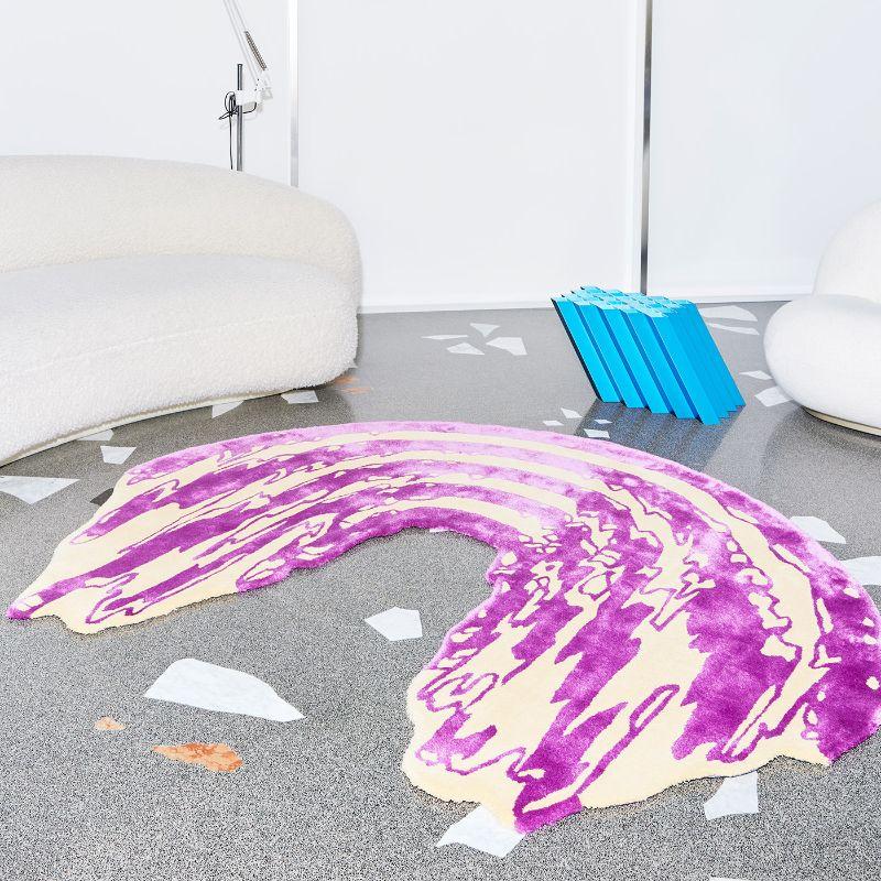 A pink and orchid-purple rainbow seemingly melting down under the caress of lava: this is the look and inspiration behind this glamorous rug from 