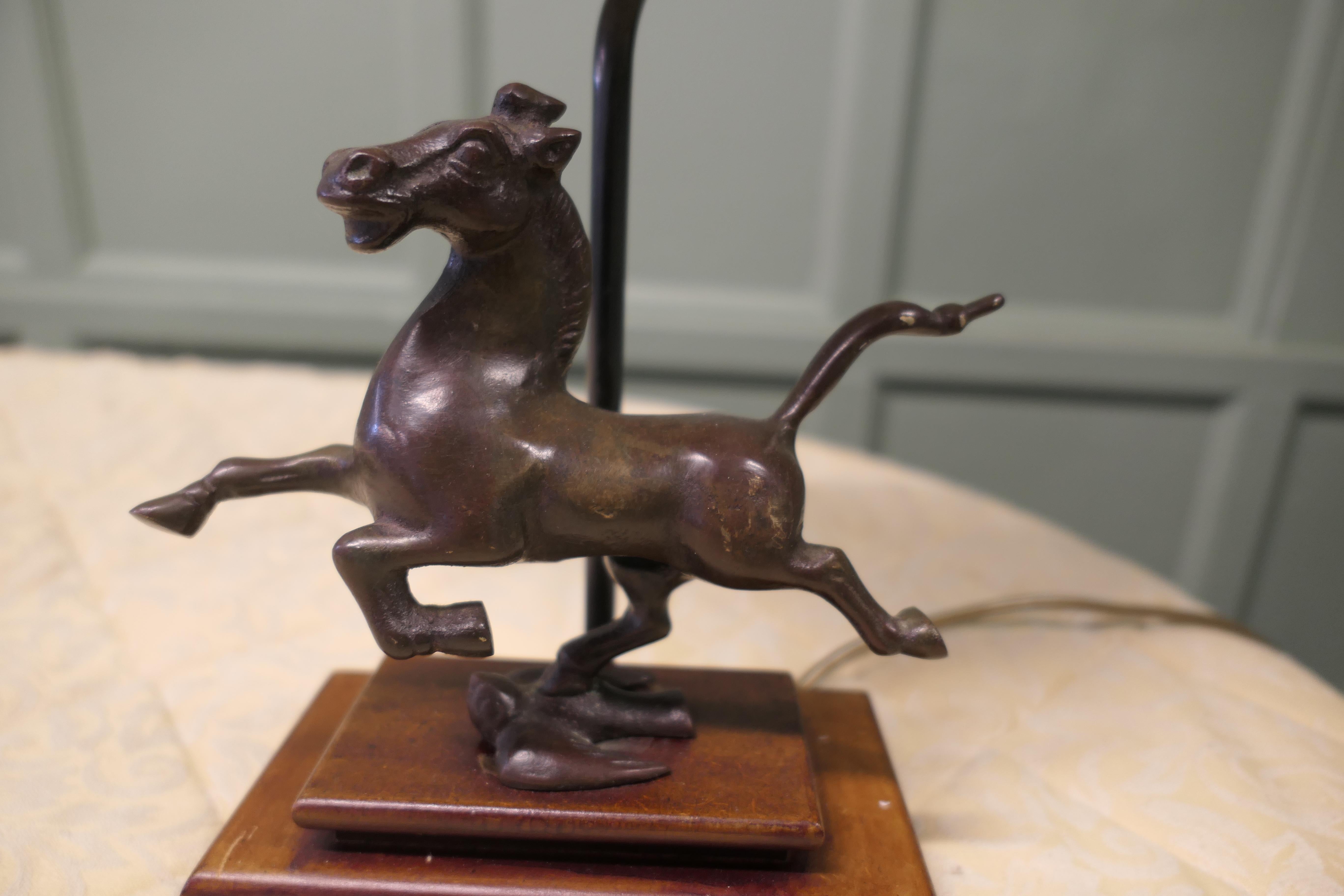 The Flying Horse of Gansu Set as a Lamp 

This is a bronze statue of The Flying Horse of Gansu otherwise known as the Galloping Horse, he is standing on a Flying Swallow
A Beautiful piece set on wood and fully working, 20” tall ads 10” wide and
