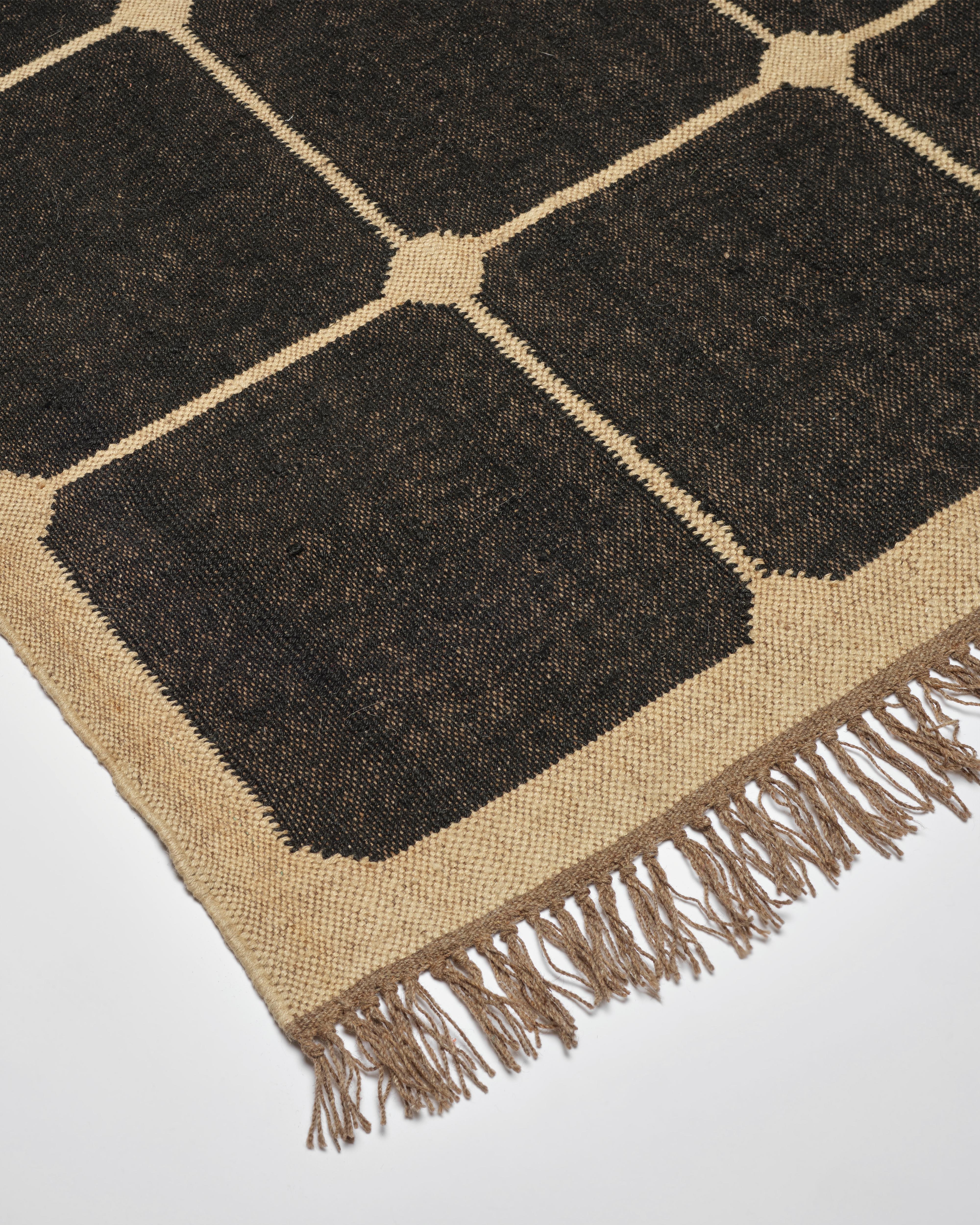 Our beautiful wool and jute checkerboard rugs are expertly handwoven in Jaipur, India. The checkerboard pattern and neutral off black & natural coloring are chic and sophisticated with a hint of bohemian cool. The flat weave is perfect for layering