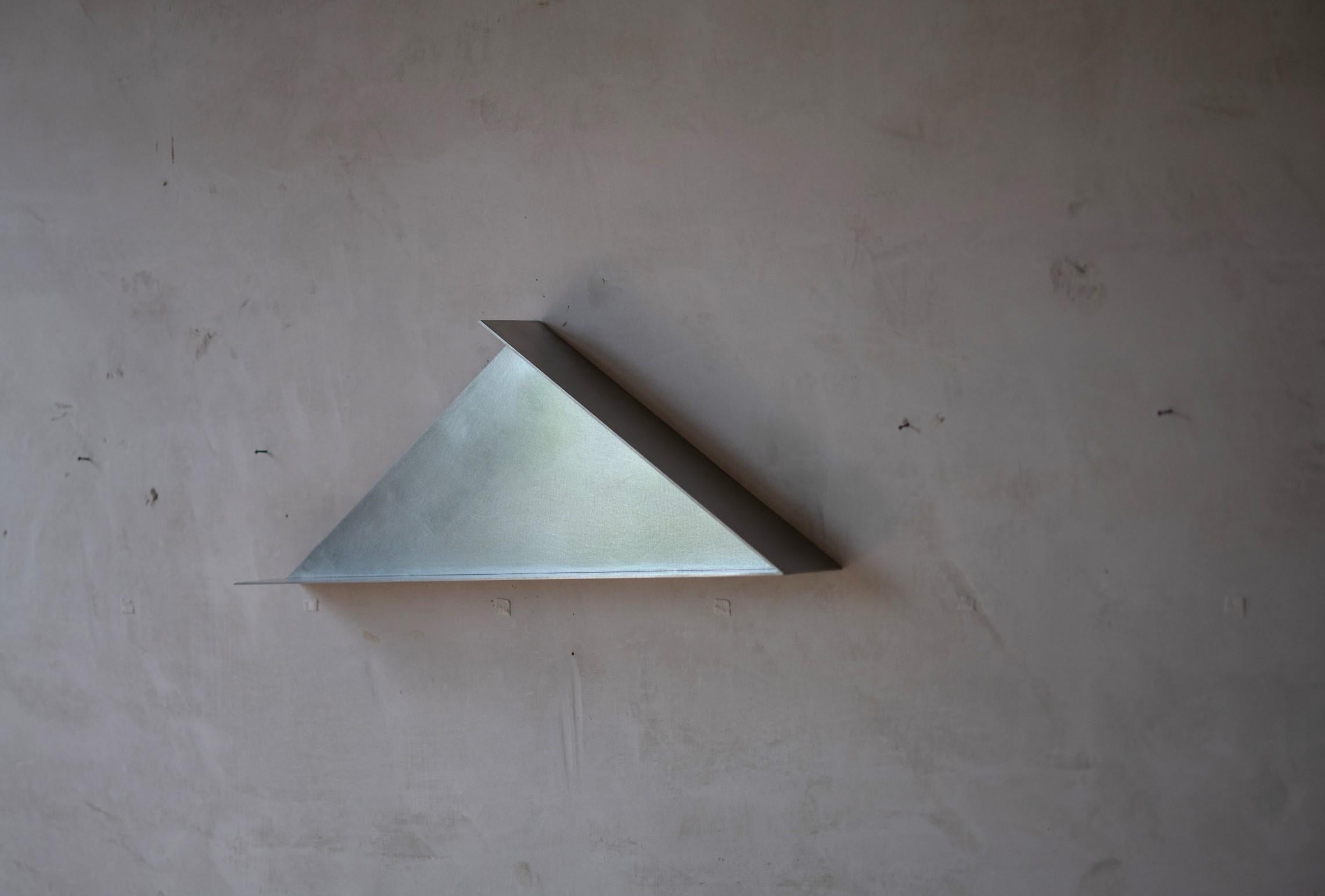 The Front Shelf by Coseincorso
Limited Edition Of 24 + 1 prototype + 2 A.P.
Dimensions: D 8 x W 75 x H 25 cm.
Materials: Stainless steel.
Weight: 1 kg.
 
The Front is inspired by the pediment of a temple. It can be used as a small shelf or an