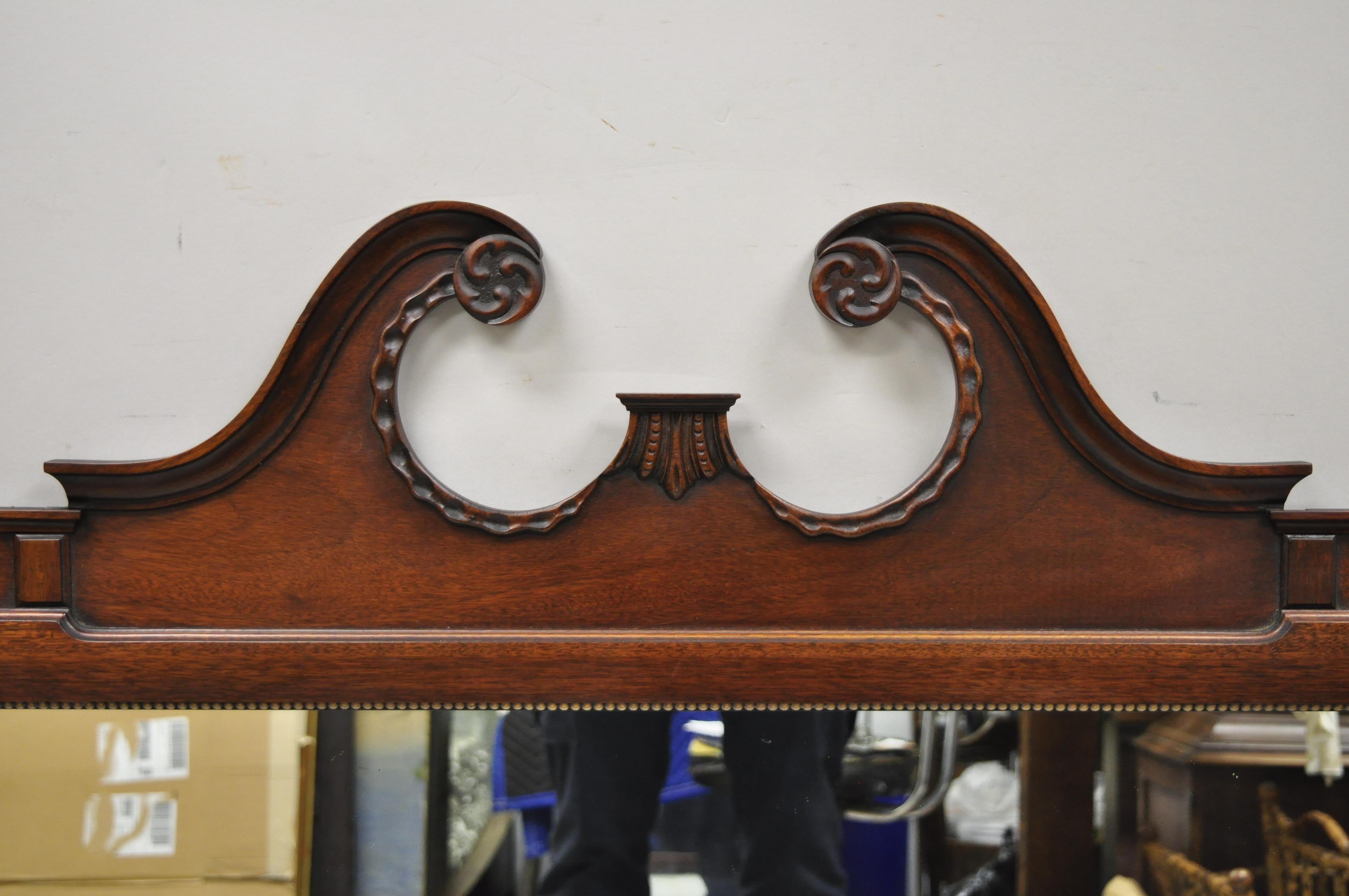 The Georgetown Galleries mahogany Chippendale broken Arch dresser wall mirror. Item features solid wood frame, nicely carved details, original label, very nice antique item, quality American craftsmanship. Circa Early 20th Century. Measurements: 41