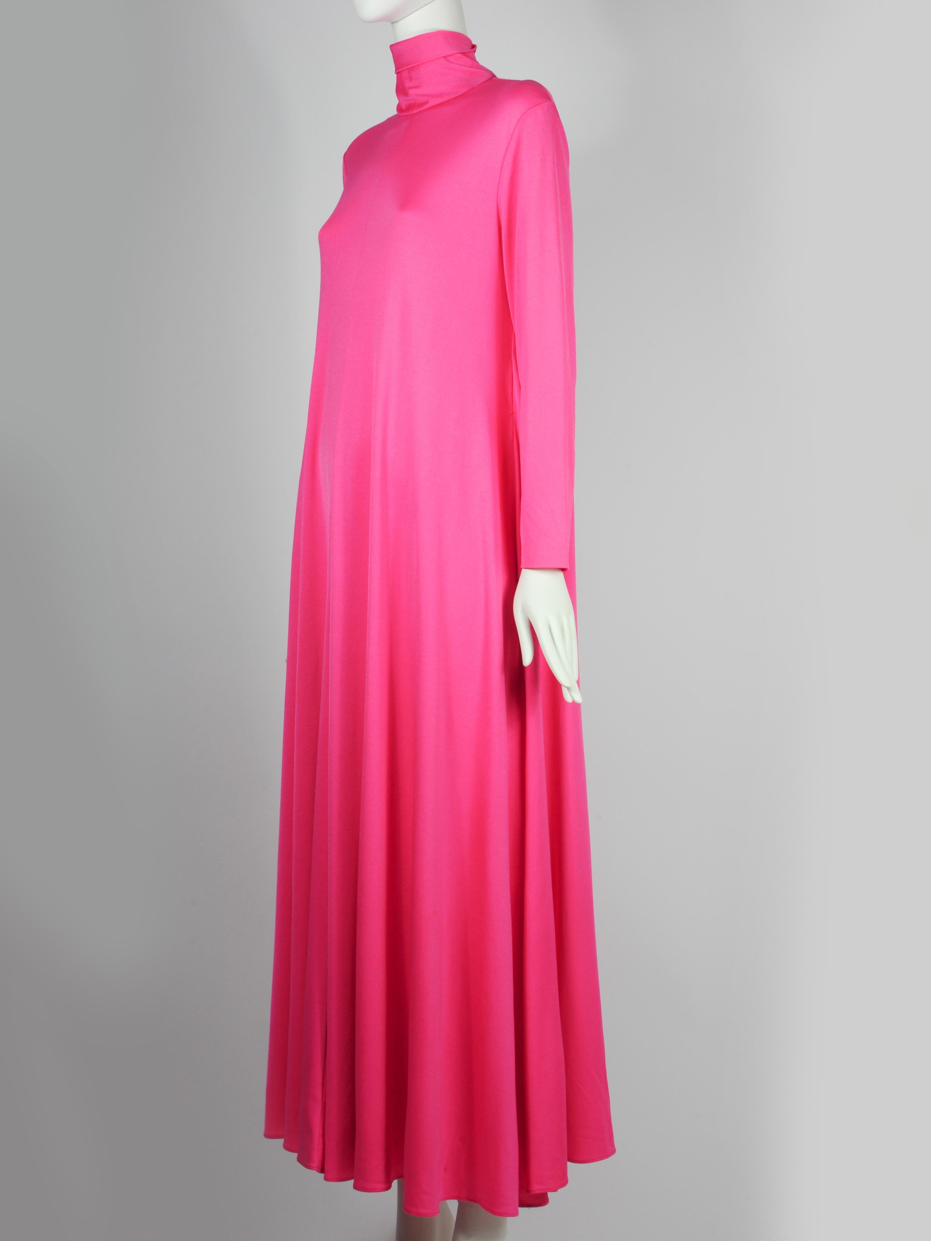 Fuchsia pink spandex maxi dress by The Gilberts for Tally New York. It is both minimalist as maximalist at the same time. There is a lot of the spandex fabric that will beautifully flow when you walk. A very modern 1970s design.

BRAND