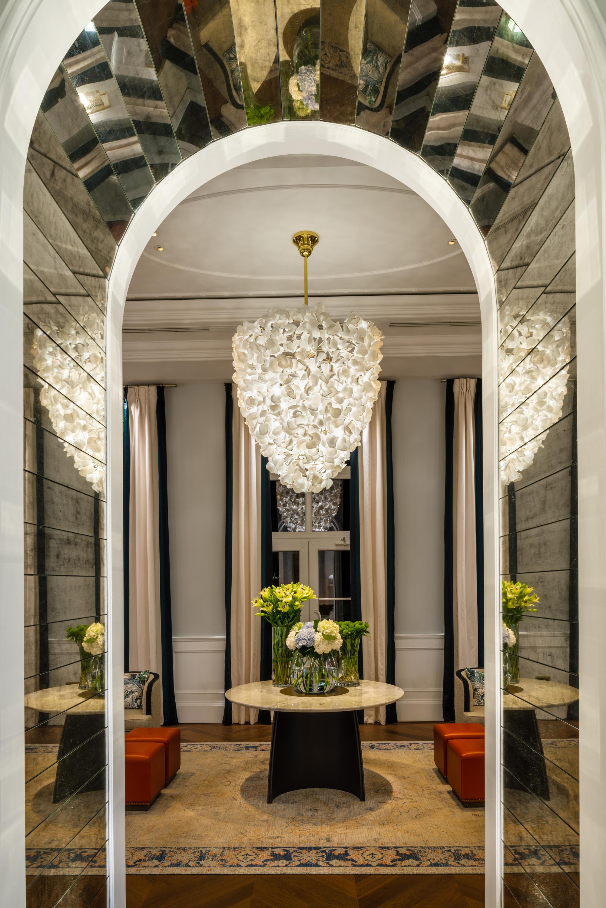 Made from the finest Bohemian crystal glass, this bespoke petal chandelier is designed with bunches of 5-8 x opal glass petals, some with gilt edging. 
Polished brass metalwork finish or powdercoated options available.
Top Dia: 1000mm
Bottom Dia: