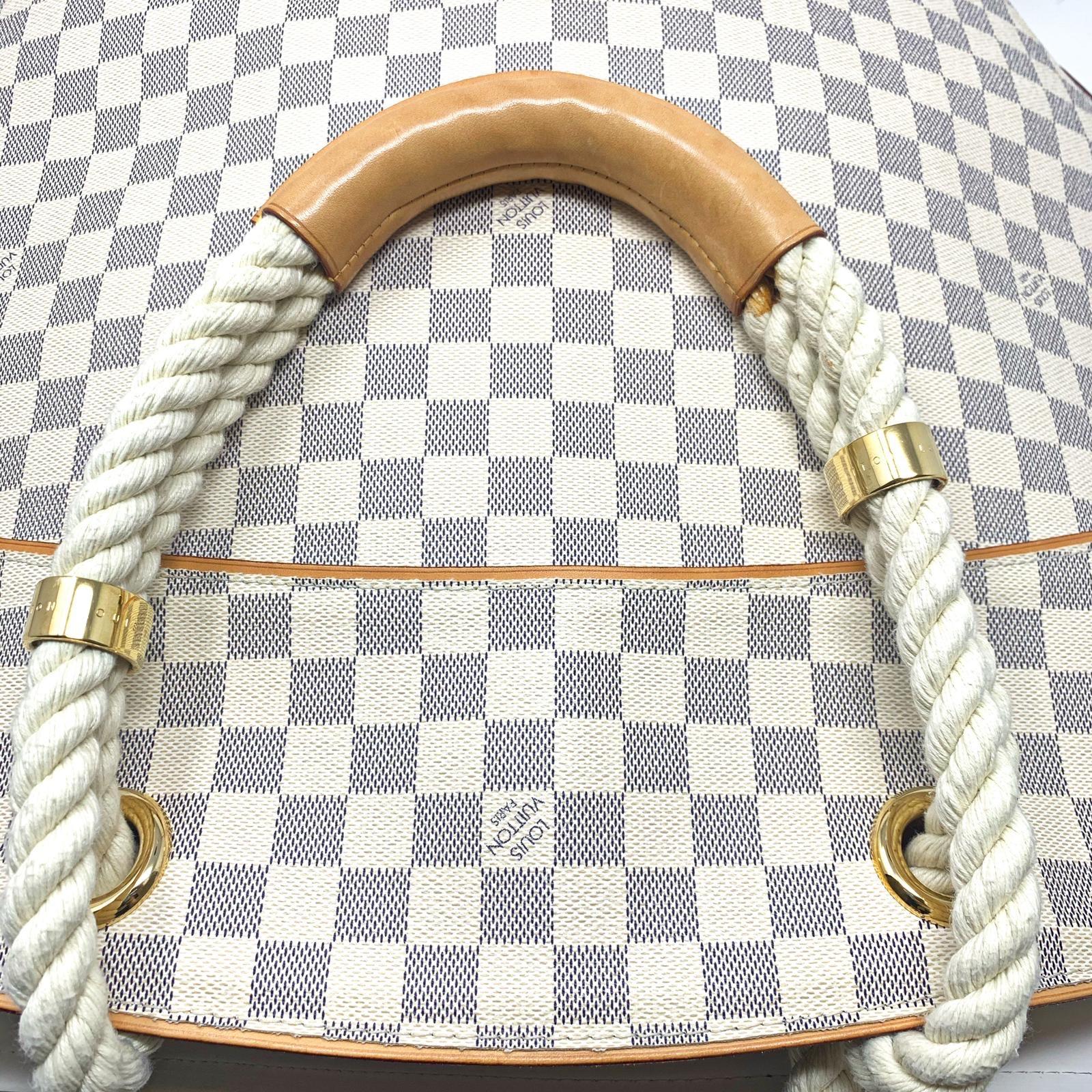 The GM Pampelonne Damier Azure Canvas bag is from the Cruise 2007 collection and features natural leather finishes, double-rope handles with leather rings and gold brass engraved 'Louis Vuitton'. The spacious interior features four large flat