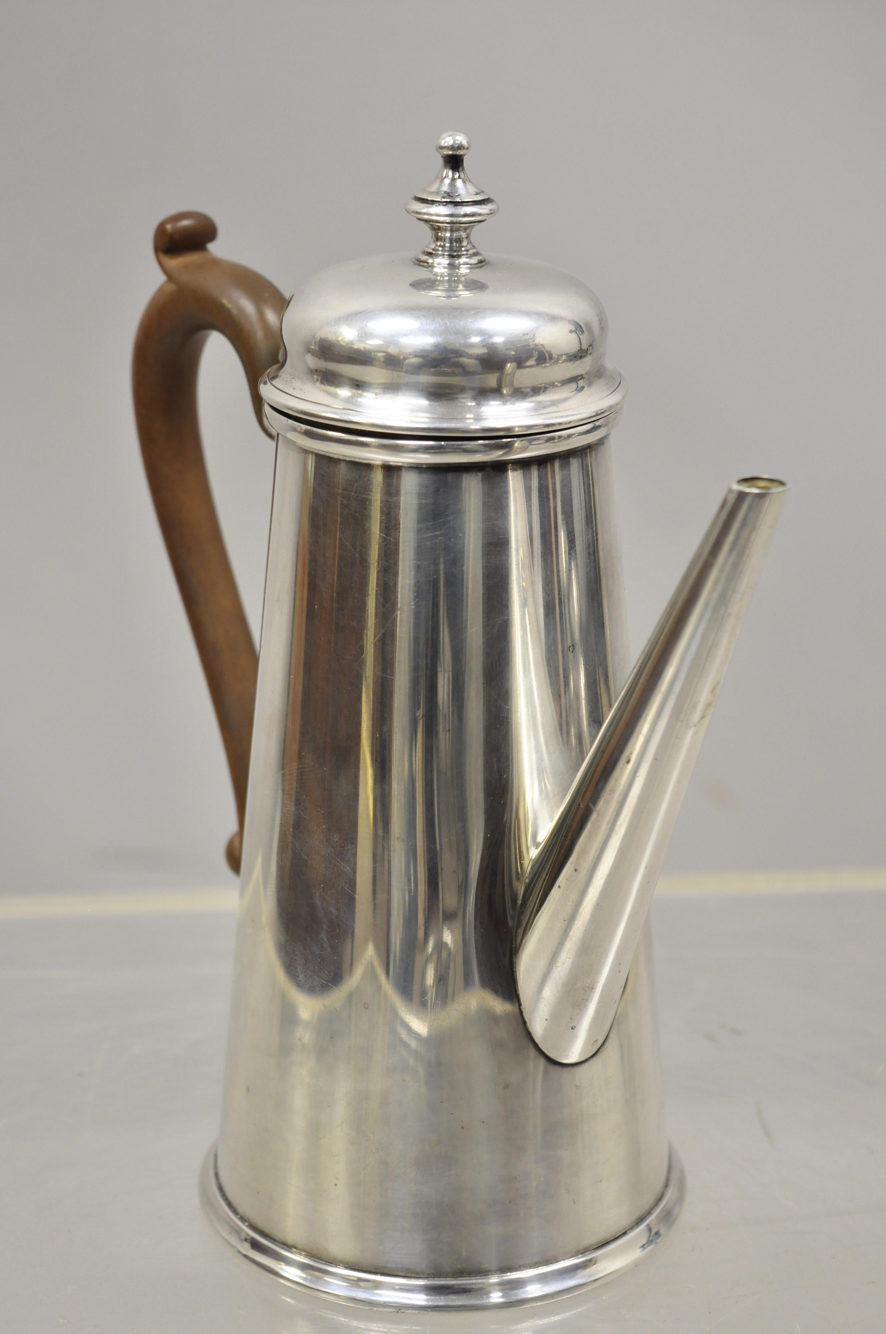 The Goldsmiths & Silversmiths Co silver plate wood handle modern coffee tea pot. Item features carved wood handle, marked to underside 