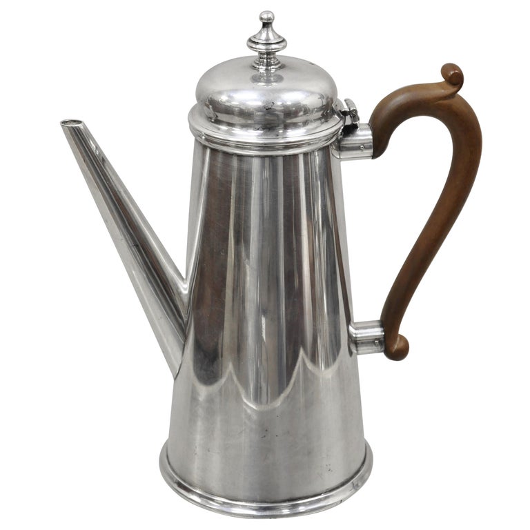 https://a.1stdibscdn.com/the-goldsmiths-silversmiths-co-silver-plate-wood-handle-modern-coffee-tea-pot-for-sale/1121189/f_220190221610022852411/22019022_master.jpg?width=768