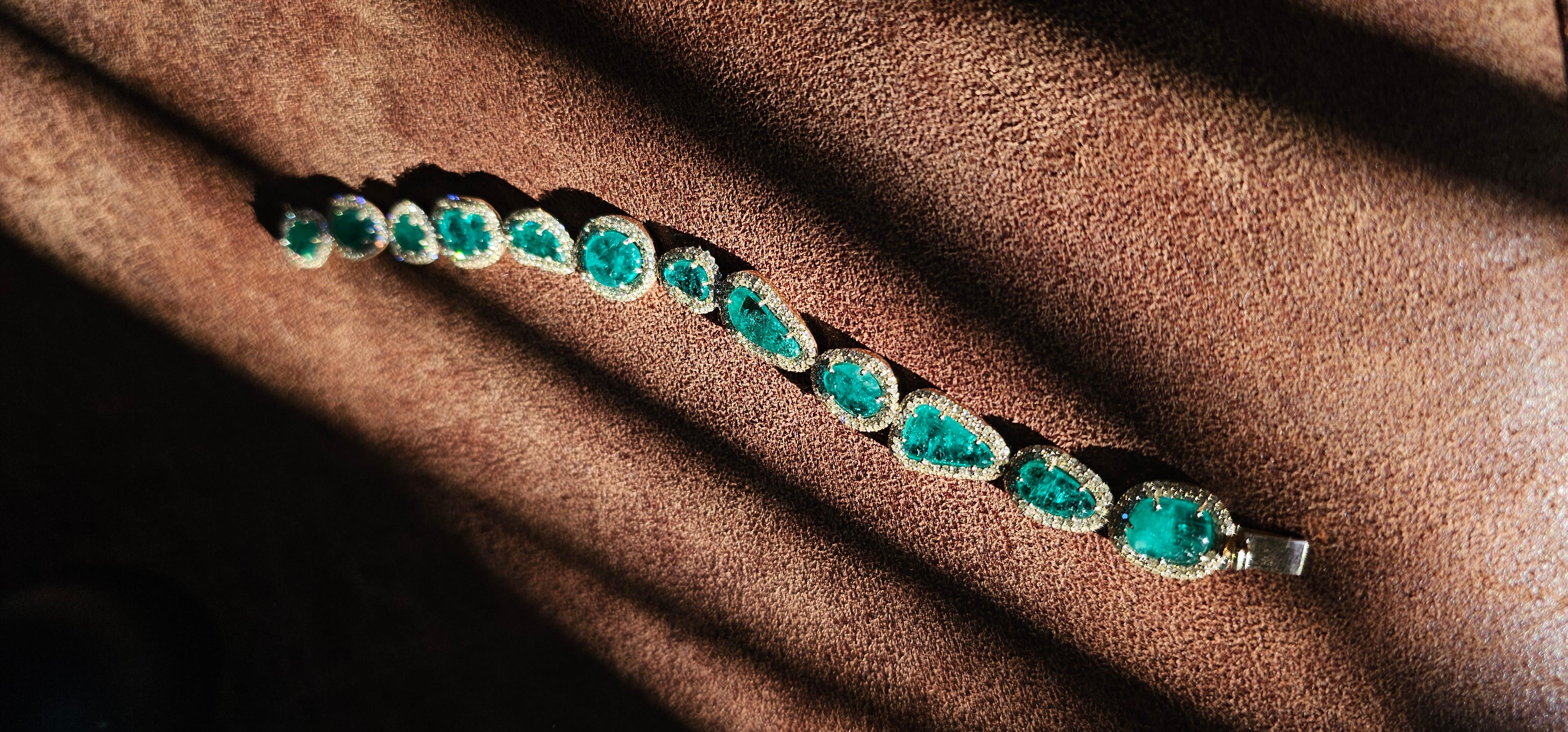 POIDS BRUT 24,08 GRAMMES 14K
NATURE COLOMBIENNE EM- 19.440 CARAT
DIAMANTS NATURELS - 4,880 CARATS

Voici le bracelet Green Ocean - une création époustouflante et unique en son genre qui donne vie à la beauté inégalée de la nature. Ce bracelet rare