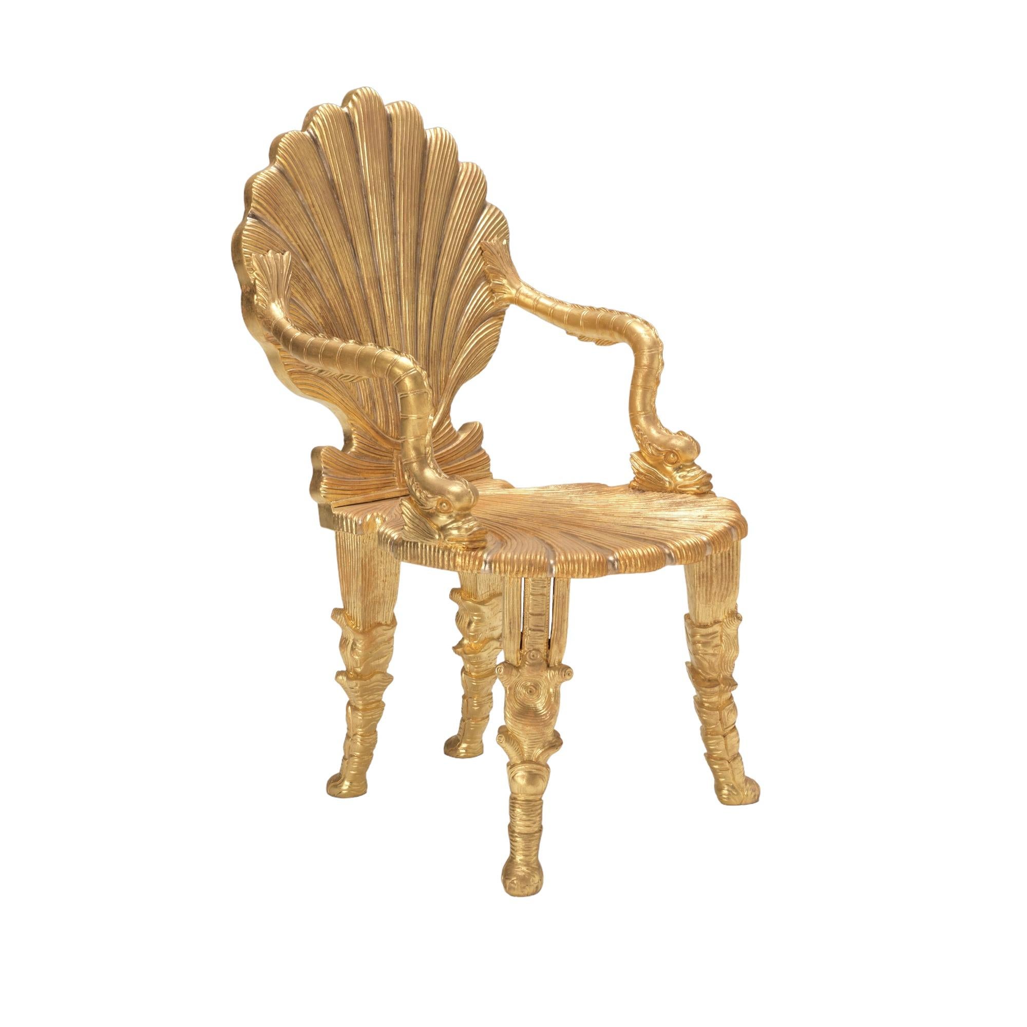 An exceptional model Grotto chair, the scallop shell back to scallop shell seat connected with stylized dolphin arms. The chairs with specialist aged grotto style gilding.