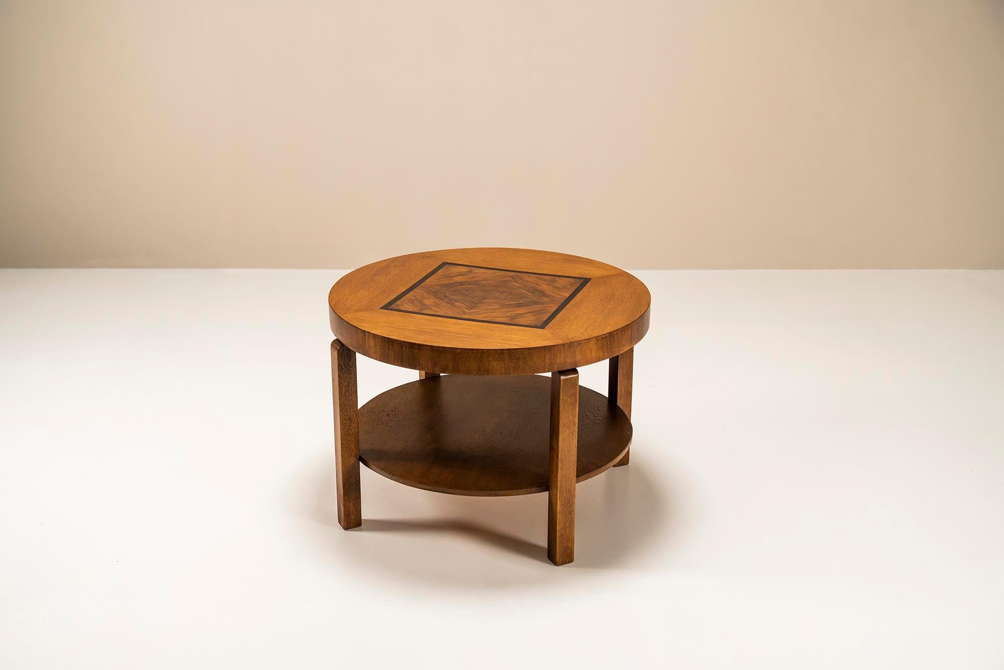 The Hague School round coffee in oak, walnut and ebony.  This coffee table has a calm and balanced appearance and is a beautiful example of the The Hague School. This is the counterpart of the Amsterdam School, which is characterized by fewer frills