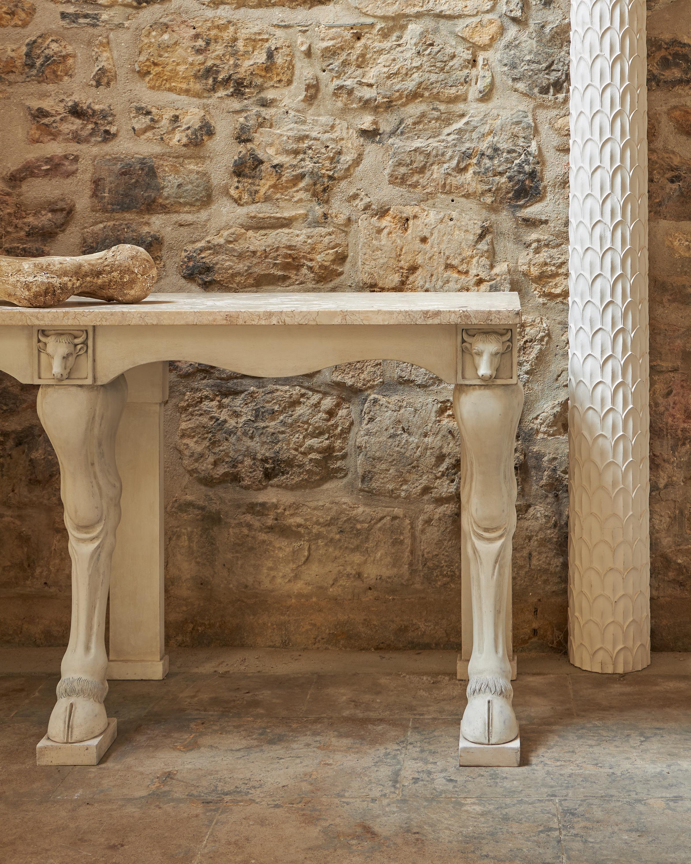 A fine carved wood console, the design taken from the 18th century dairy room at Ham House, Richmond, Surrey. The console with a generous 30mm marble top supported by three cows legs with hooves. The three carved legs are topped with square blocked