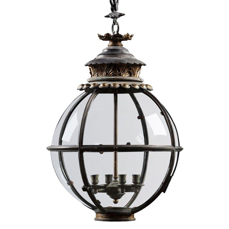 A spherical hanging lantern with moulded glazing bars and a hinged access pane. The top is decorated with gilded foliage beneath a petal shaped smoke cap with foliate rose and a gilt bead collar.
 