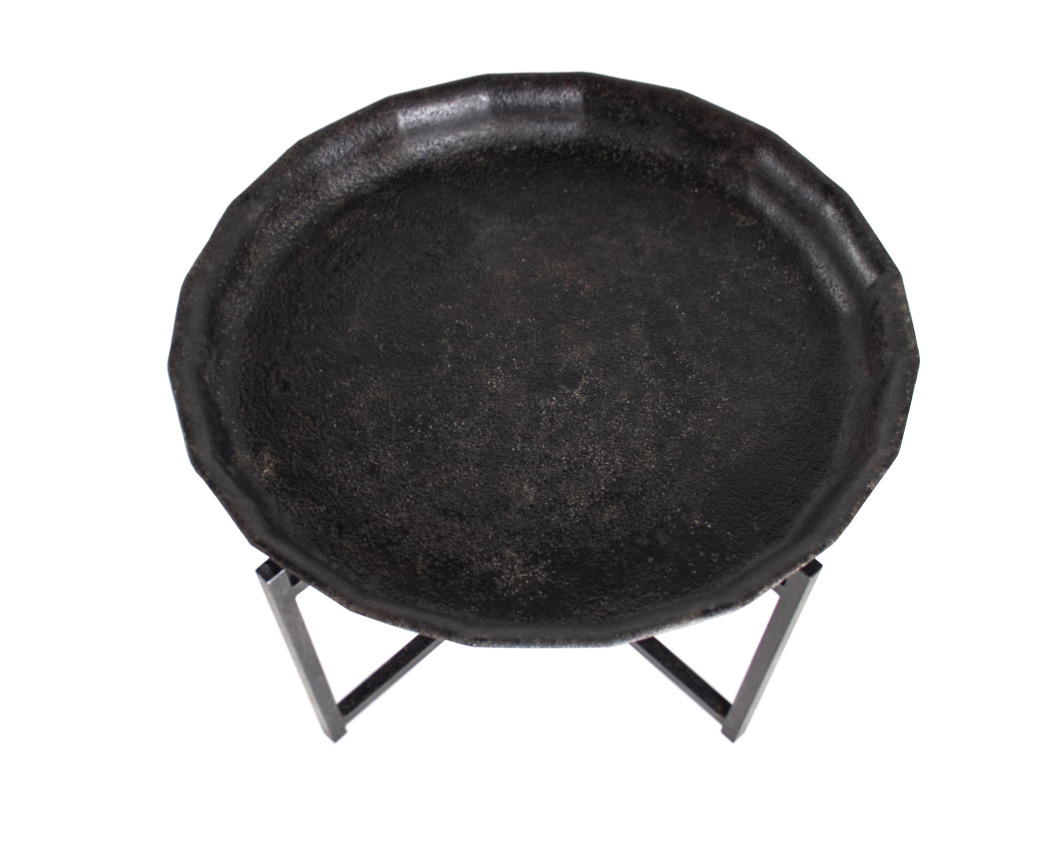 Cast iron fire pit plateau on cast iron geometric stand.

The Harn is an indoor or outdoor furnishing, intended as a side table. 

A part of our Le Monde collection. Exclusive to Brendan bass.
