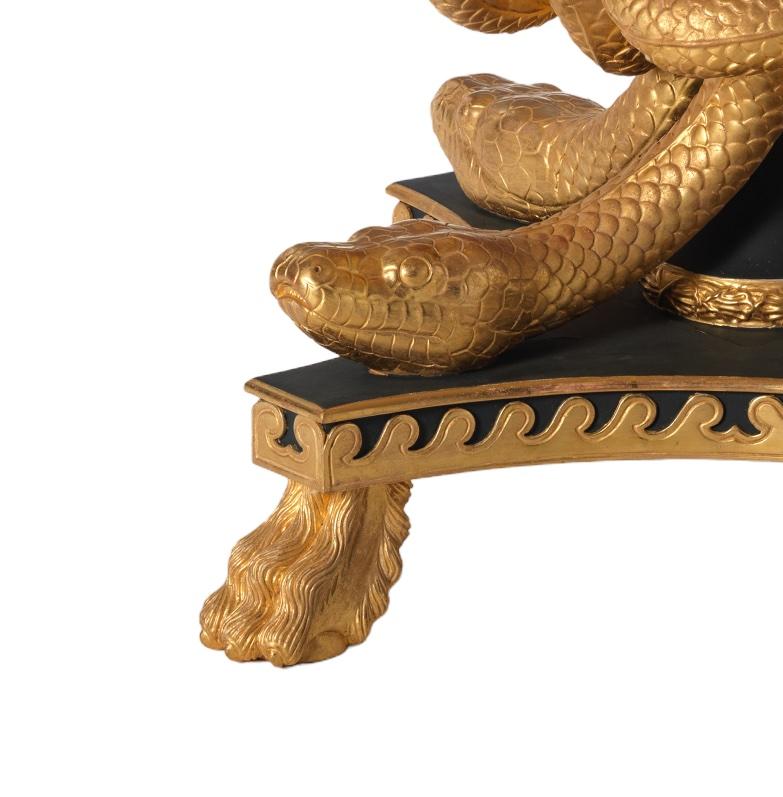 A fine circular Thomas Hope design entwined snake centre table. A marble top rests upon a moulded frieze supported on extraordinary, intertwined pythons surrounding a central column. All resting upon a four concave sided platform base with applied