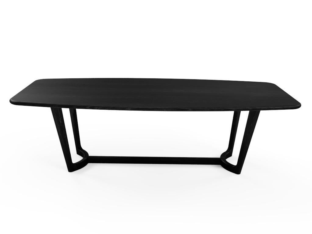A beautiful Mid-Century Modern take on the dining table. Made out of solid White Ash in an ebonized black finish, this table is made without a single sharpe edge giving it soft feel and keeping your space feeling light. A slight curve to the table