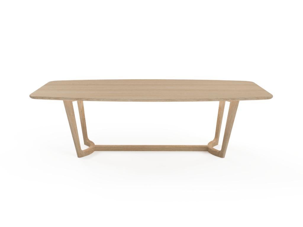 A beautiful Mid-Century Modern take on the dining table. Made out of solid White Oak, this table is made without a single sharpe edge giving it soft feel and keeping your space feeling light. A slight curve to the table top and gently tapered legs