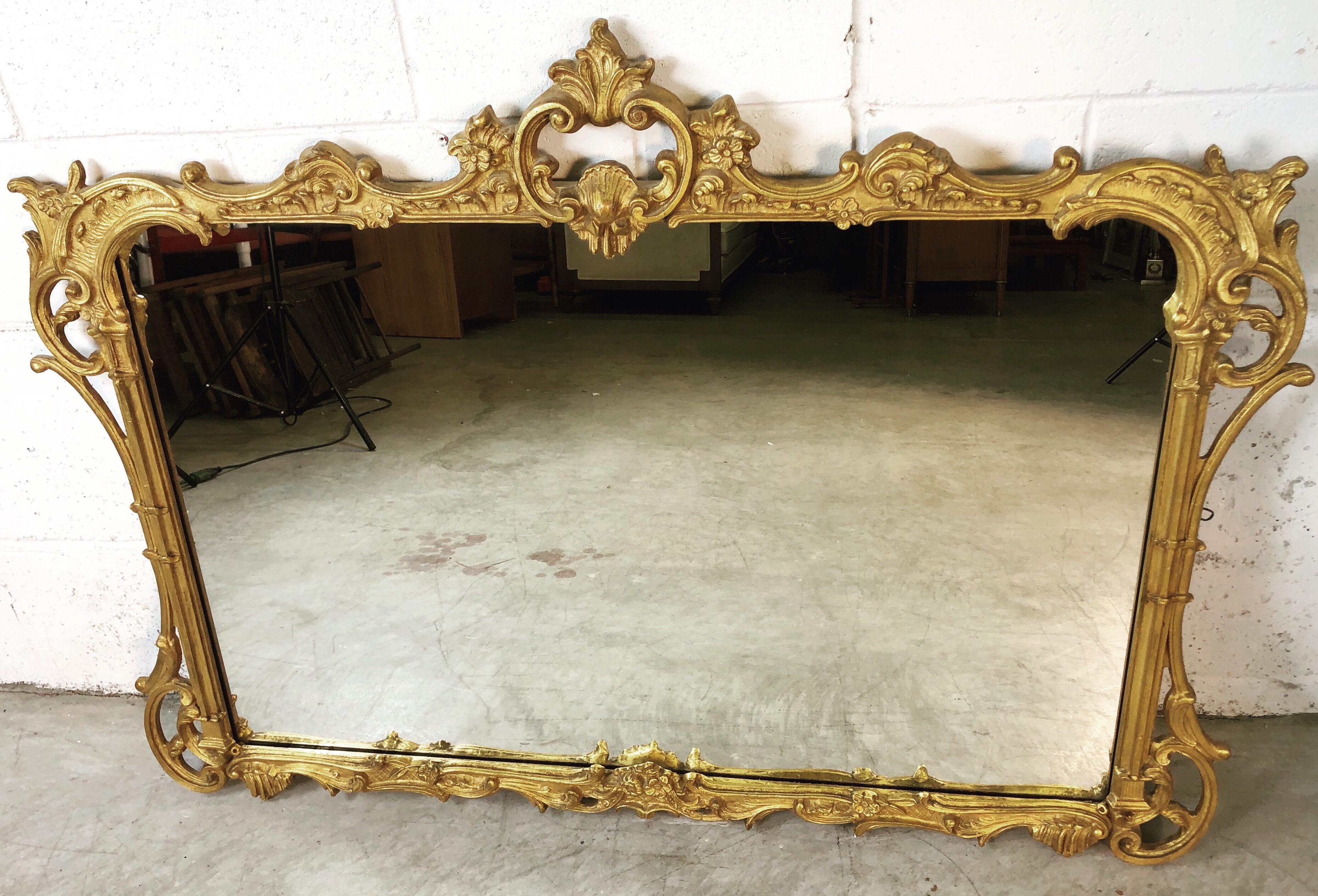 The House of Dinsmore mirror designed by the Friedman Brothers Decorative Arts Co of New York. Beautifully hand carved and gilded wall mirror. Excellent condition. Marked on the back. Some hardware is included.