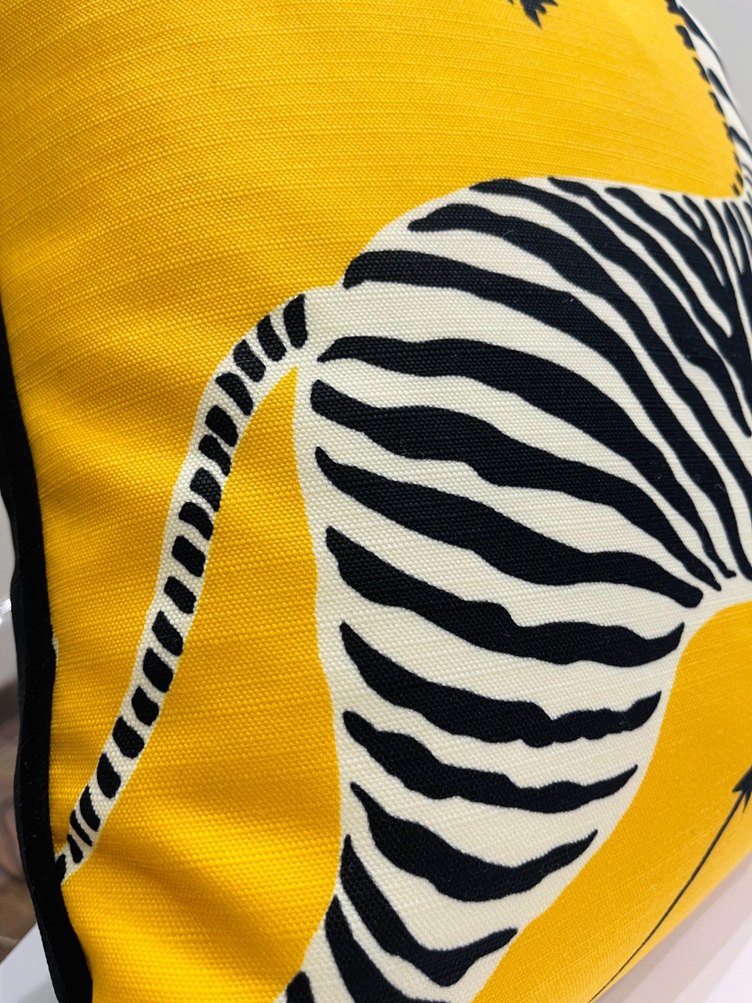 This luxury plush pillow is a product of the Art by Gomez atelier. The front is fitted with a rich sunflower yellow that supports a pattern with galloping zebras. The fabric is from the archives of the luxurious House of Scalamandre. The back is a