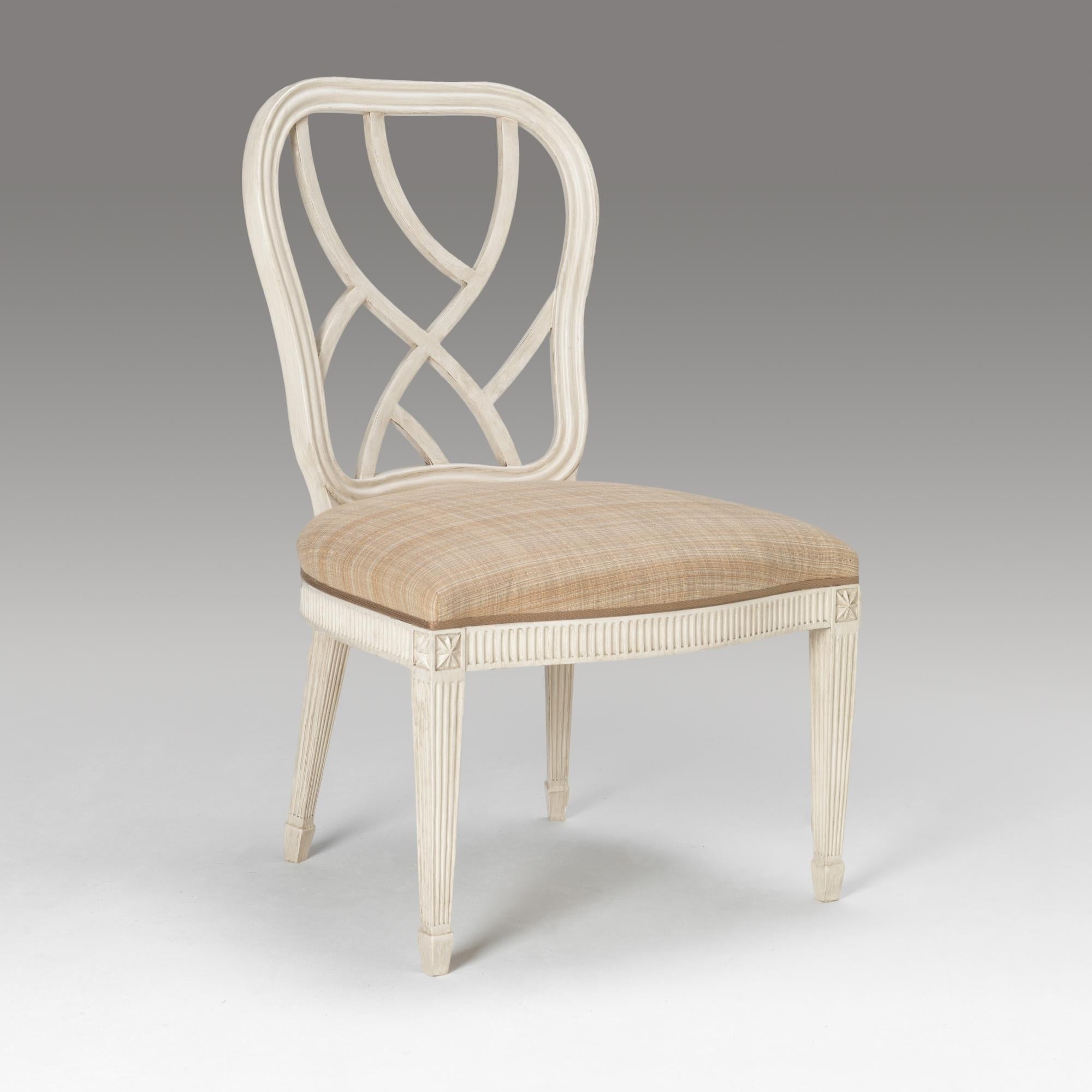 A fine Hepplewhite design lattice back dining chair. The shaped open fret back with reeded framing. The seat rail with fluted decoration. The tapered legs with recessed star panel to the top, the legs terminating in a spade design foot. To be