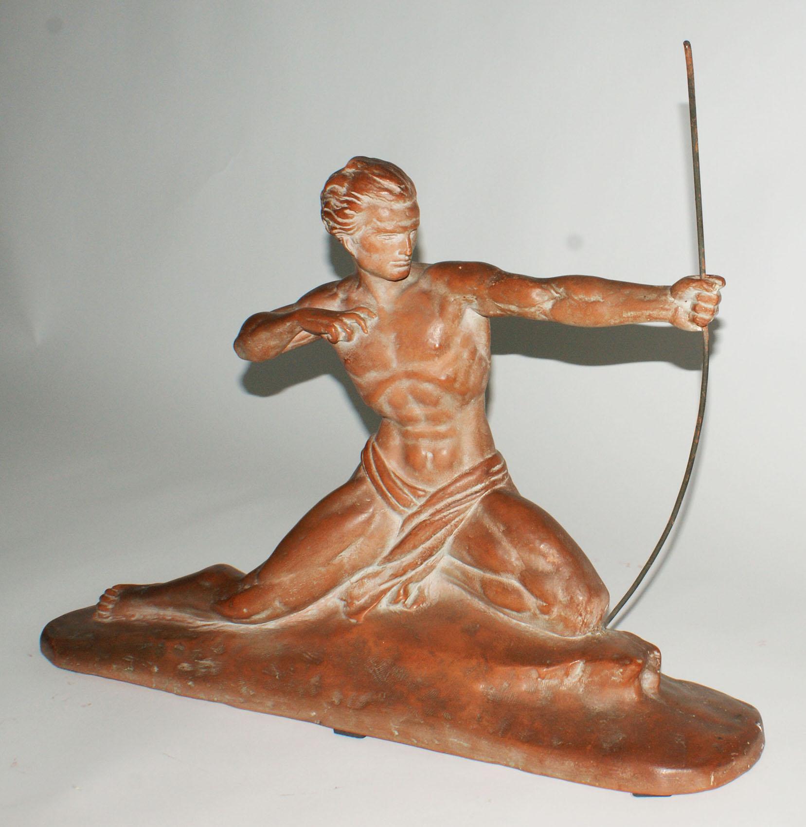 French Art Deco terracotta sculpture showing a hunter kneeling on his leg and holding by the left hand a hunting bow, with the signature of the artist on the base.