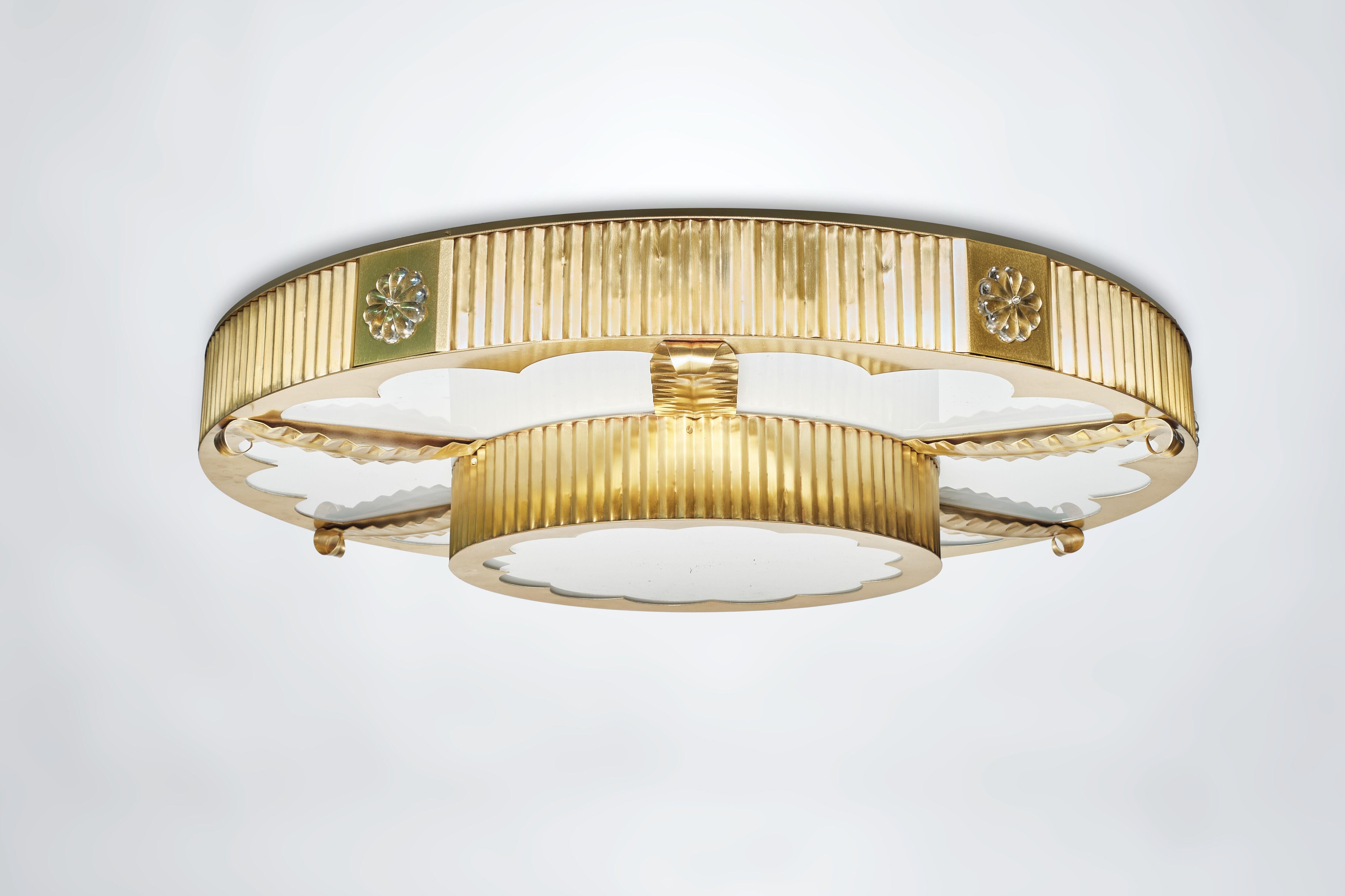 A large scale, custom Art Deco-style flush mounted light fixture designed by David Duncan. This elegant fixture features two tiers of corrugated brass sides adorned with Czech glass rosettes. 15 candelabra sockets. This light is also available as a